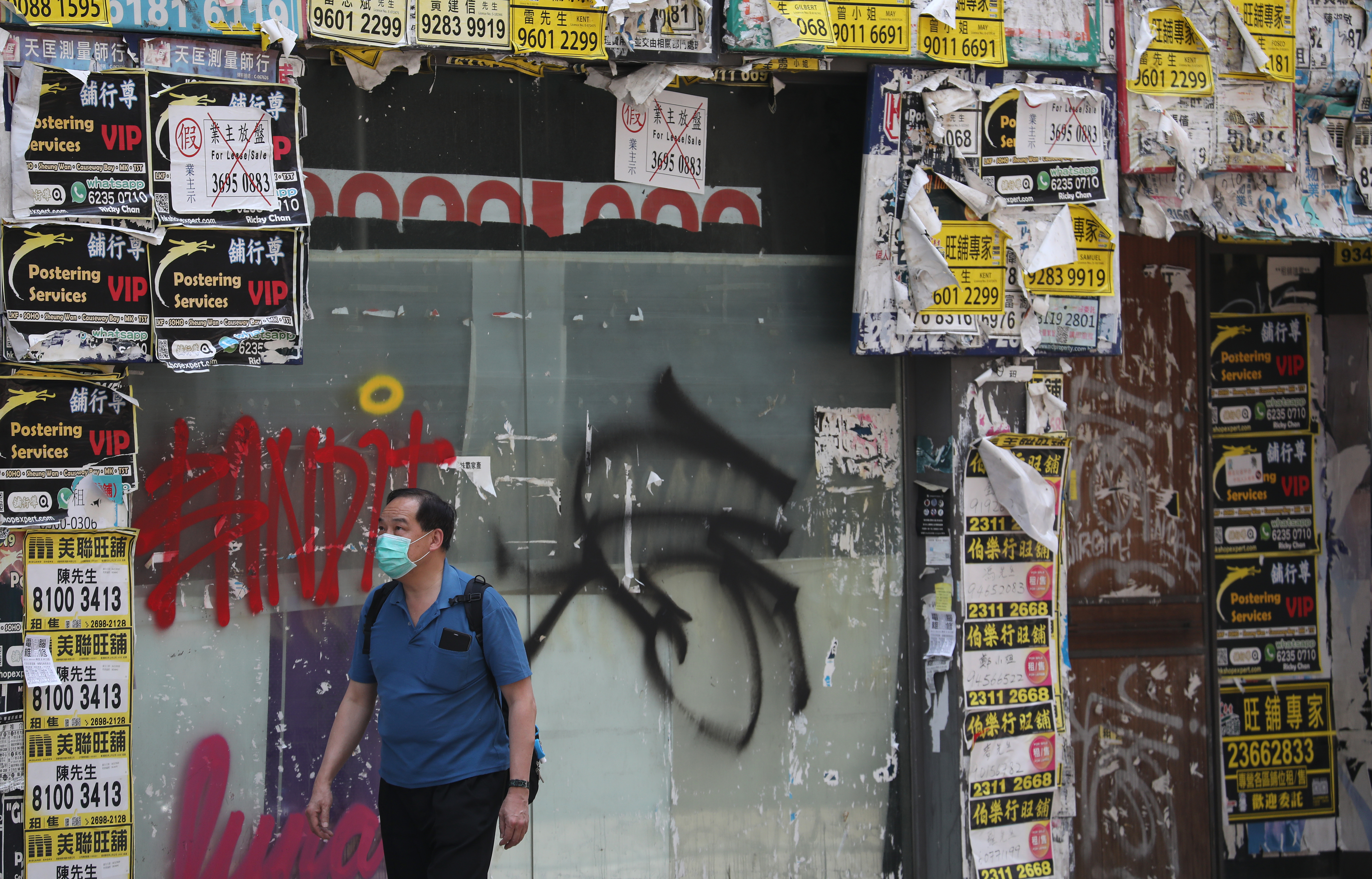 A man walks past a closed down retail store in Wan Chai. Photo: SCMP / Xiaomei Chen

