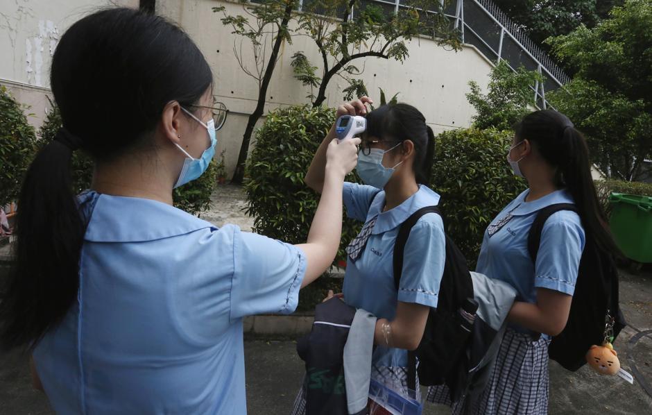 Measures like temperature taking and half-days are in place to prevent the spread of Covid-19. Photo: SCMP