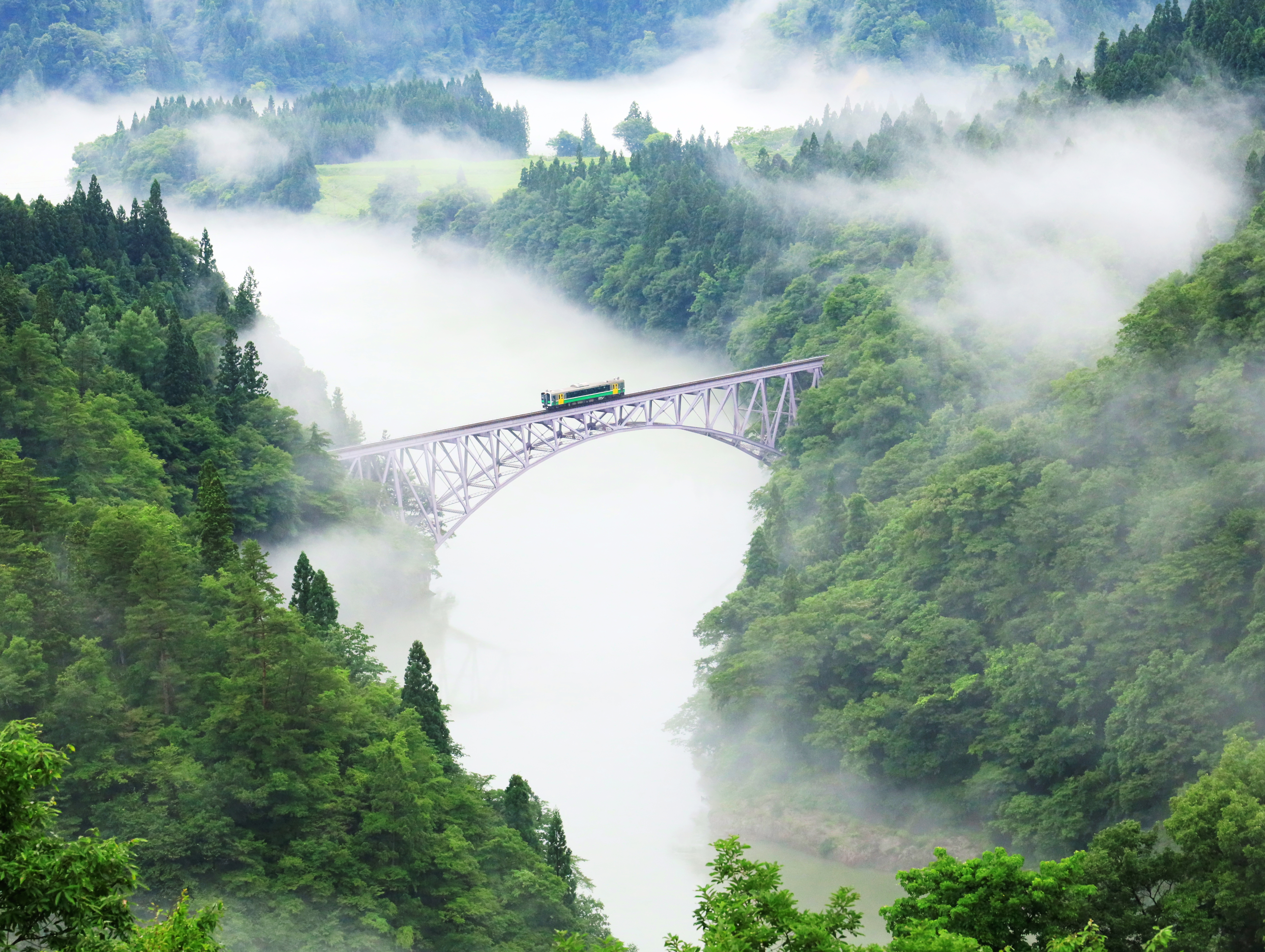 A train on the Tadami Line crosses the No 1 Tadami River Bridge between Aizu Hinohara and Aizu Nishikata in Japan. Photo: Ken Hoshi