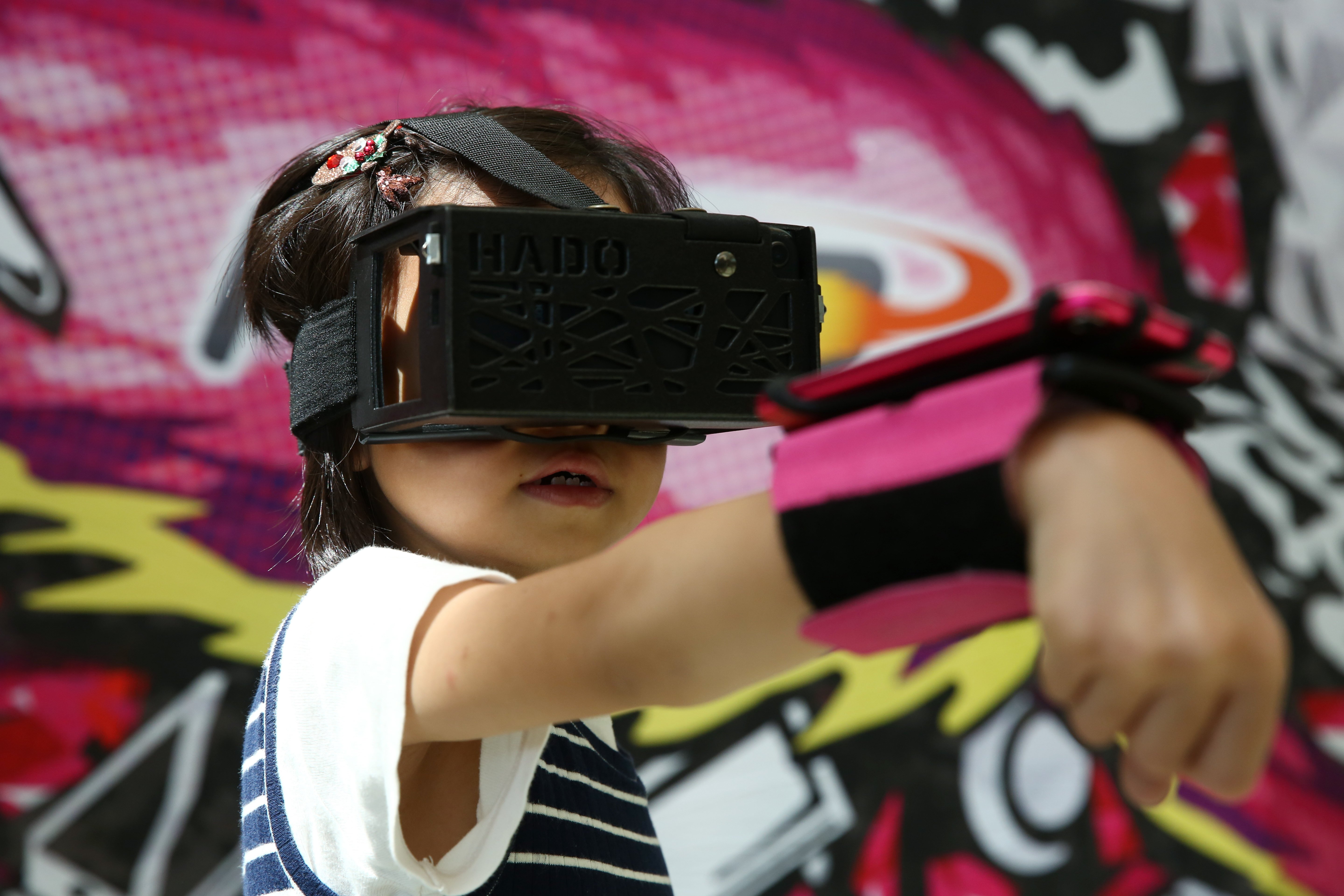 A girl plays a video game at an e-sports carnival at Cyberport in September 2018. Hong Kong’s tech hubs have an important role to play in fostering content technology. Photo: Edmond So