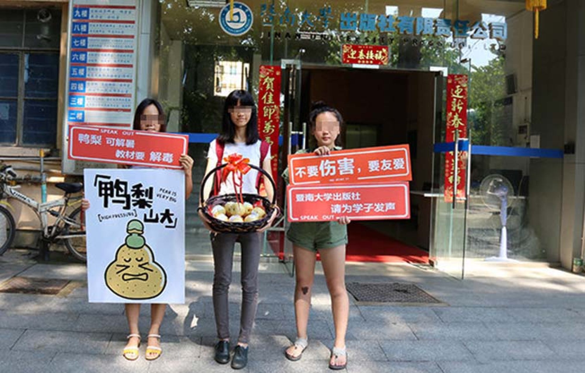 Xixi y sus amigos protestaron contra el libro de texto frente a la oficina de su editor en Guangzhou, provincia de Guangdong en julio de 2016.