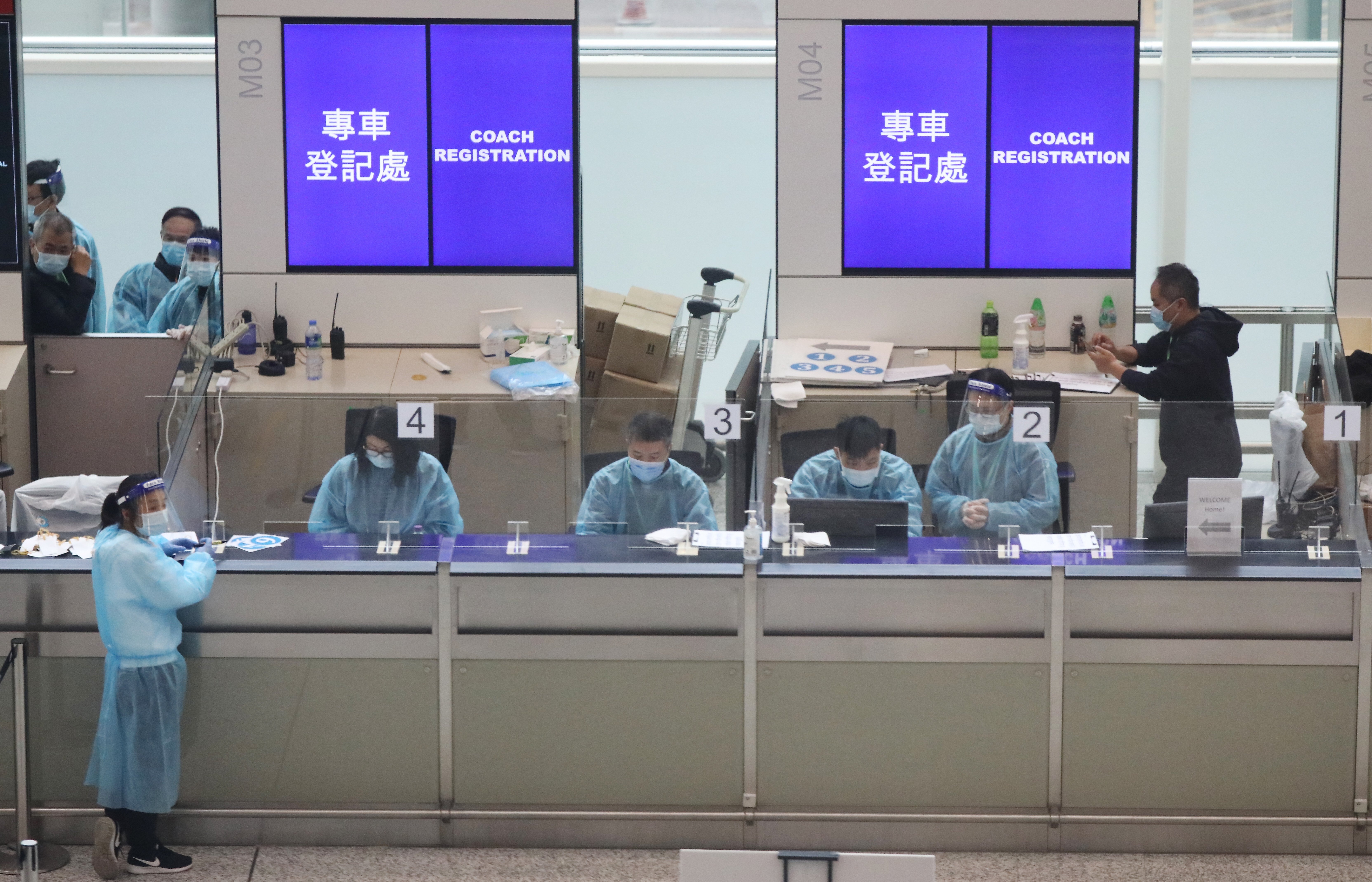 Coach registration counter at the Hong Kong International Airport, for passengers to be transported to designated quarantine hotels, on December 22. Photo: Nora Tam