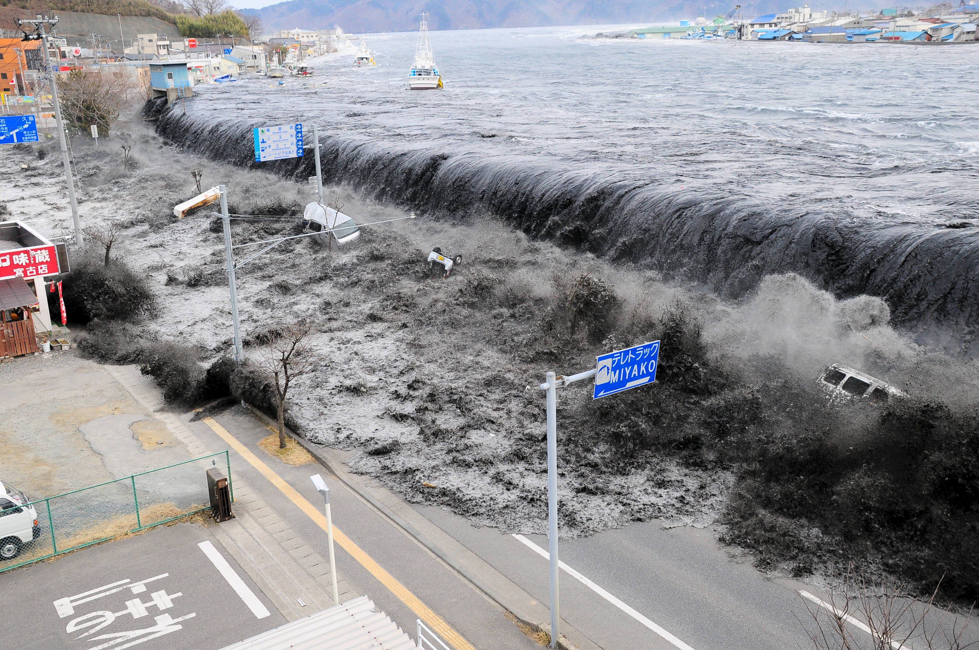 The tsunami hits the city of Miyako in northeast Japan in March 2011. Ten years on, Japan is stepping up efforts to preserve memories of the disaster. Photo: Reuters/Mainichi Shimbun