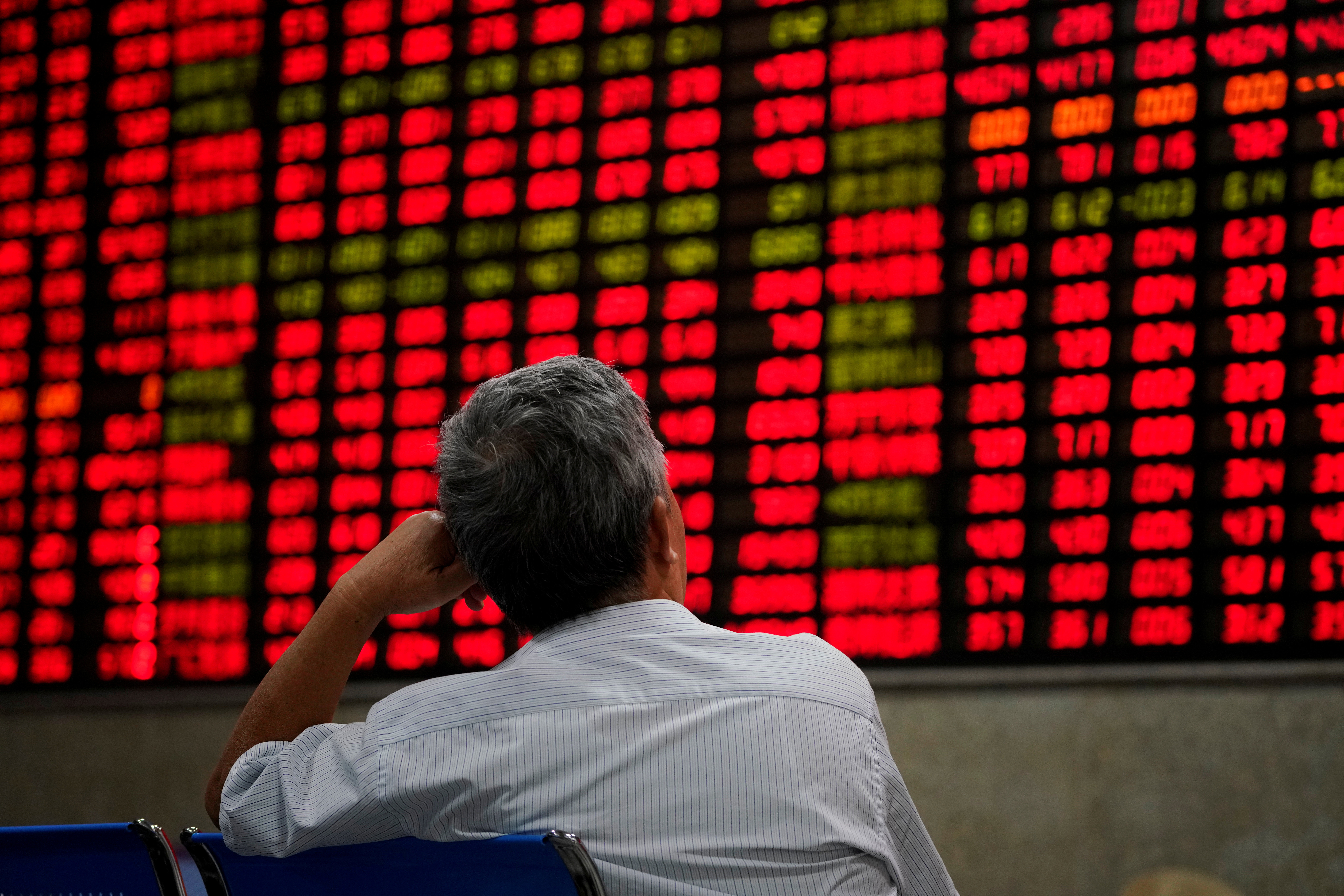 An investor staring at stock prices at a brokerage house in Shanghai during the 2018 market crash. Photo: Reuters