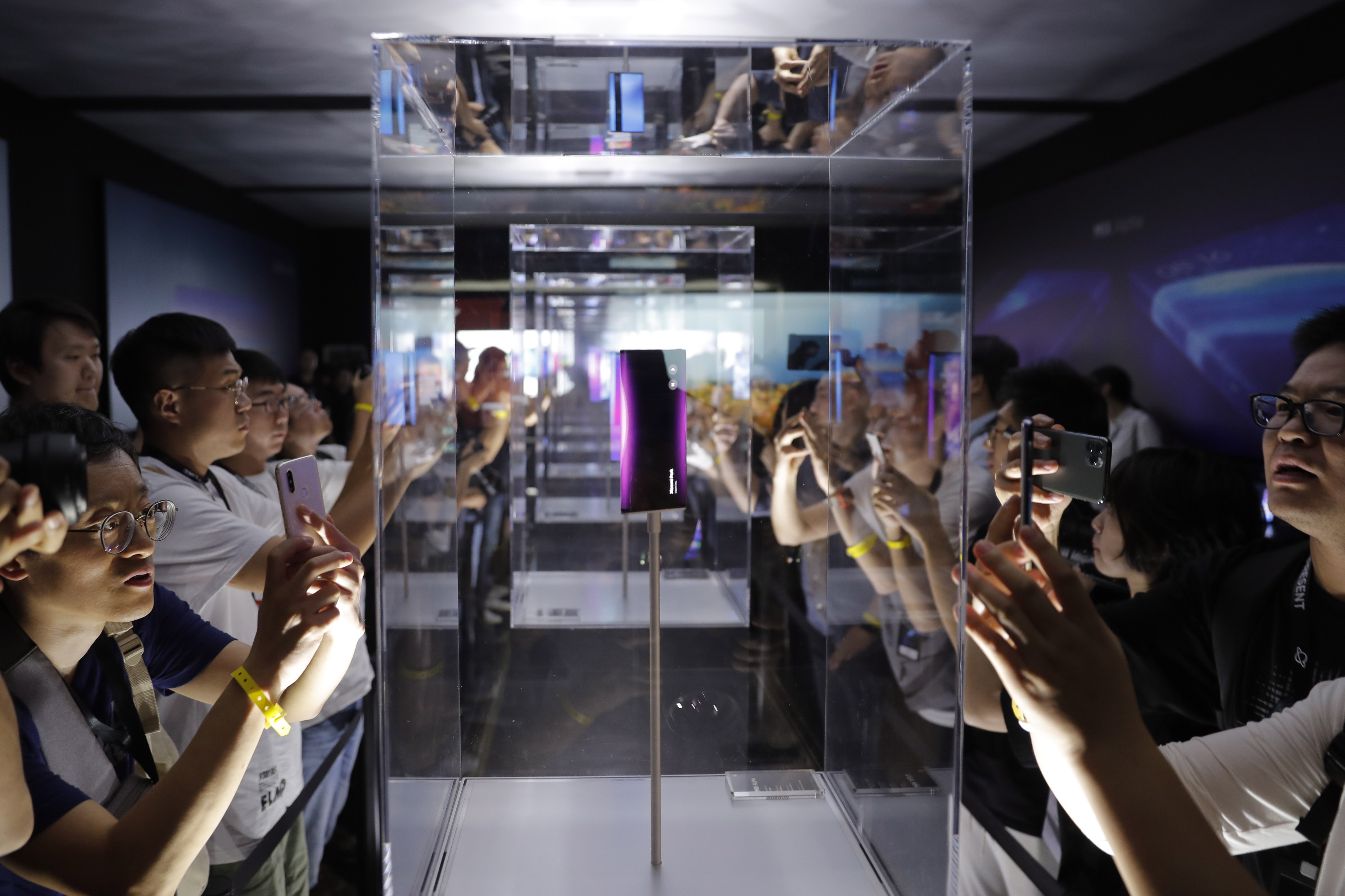 Visitors take snapshots of Xiaomi Corp’s MIX Alpha 5G smartphone at a launch ceremony in Beijing on September 24, 2019. Photo: EPA-EFE