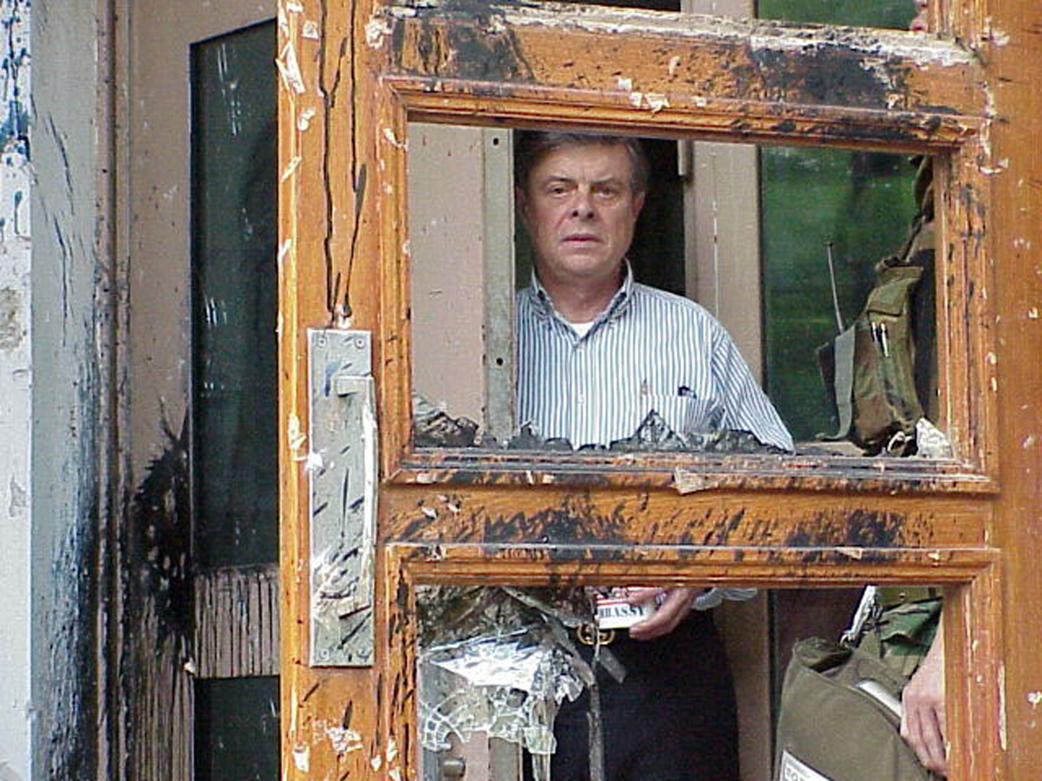 Then US ambassador to China James Sasser peers through a heavily-damaged door at the US embassy building in Beijing on May 10, 1999, following two days of attacks by Chinese protesters against Nato’s bombing of the Chinese embassy in Belgrade. Photo: Reuters