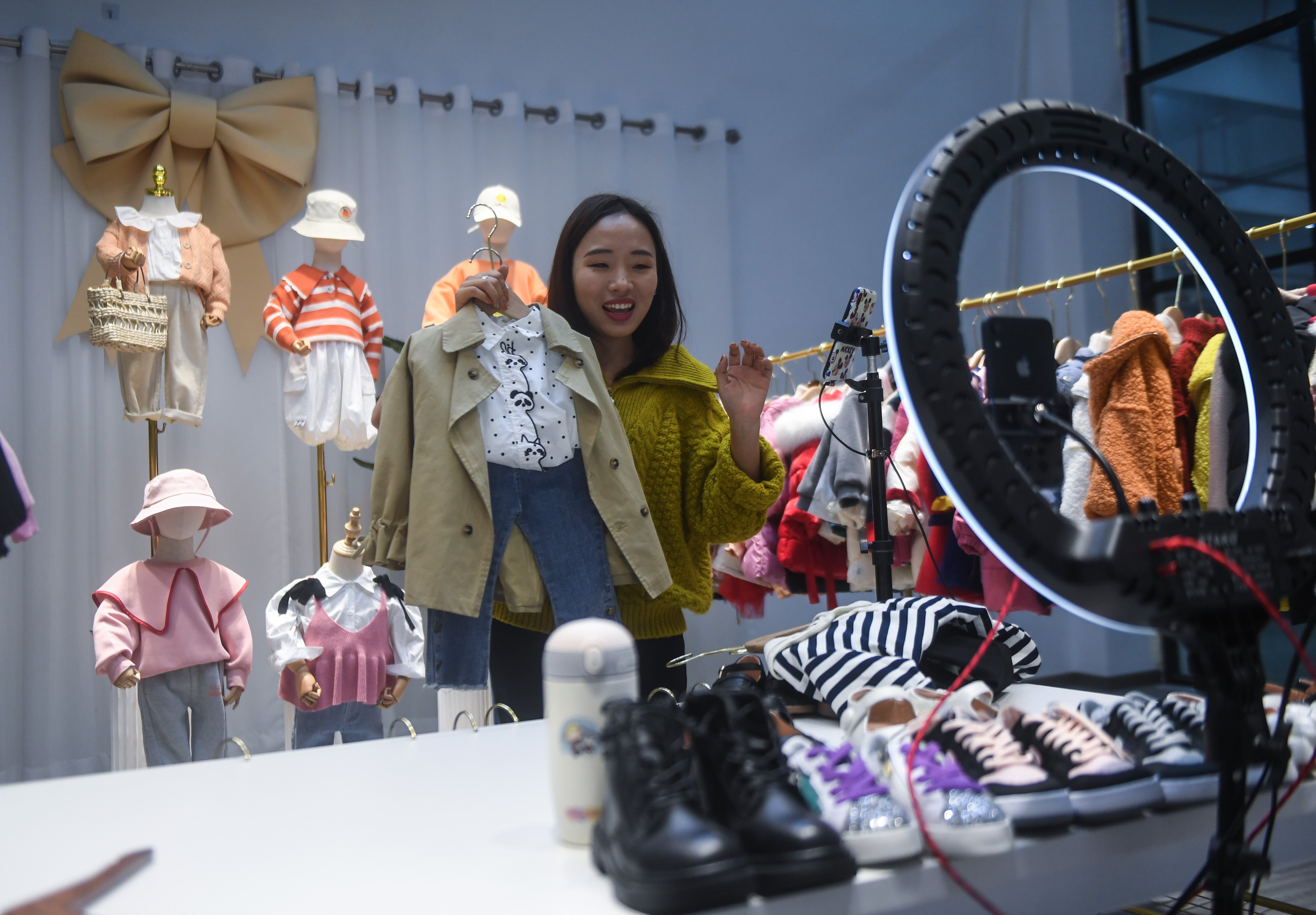 A live-streamer sells children’s clothes in Zhili town, Huzhou, Zhejiang province, on February 8. Live-streaming, group buying and new forms of social shopping are emerging in Asia as e-commerce explodes. Photo: Xinhua