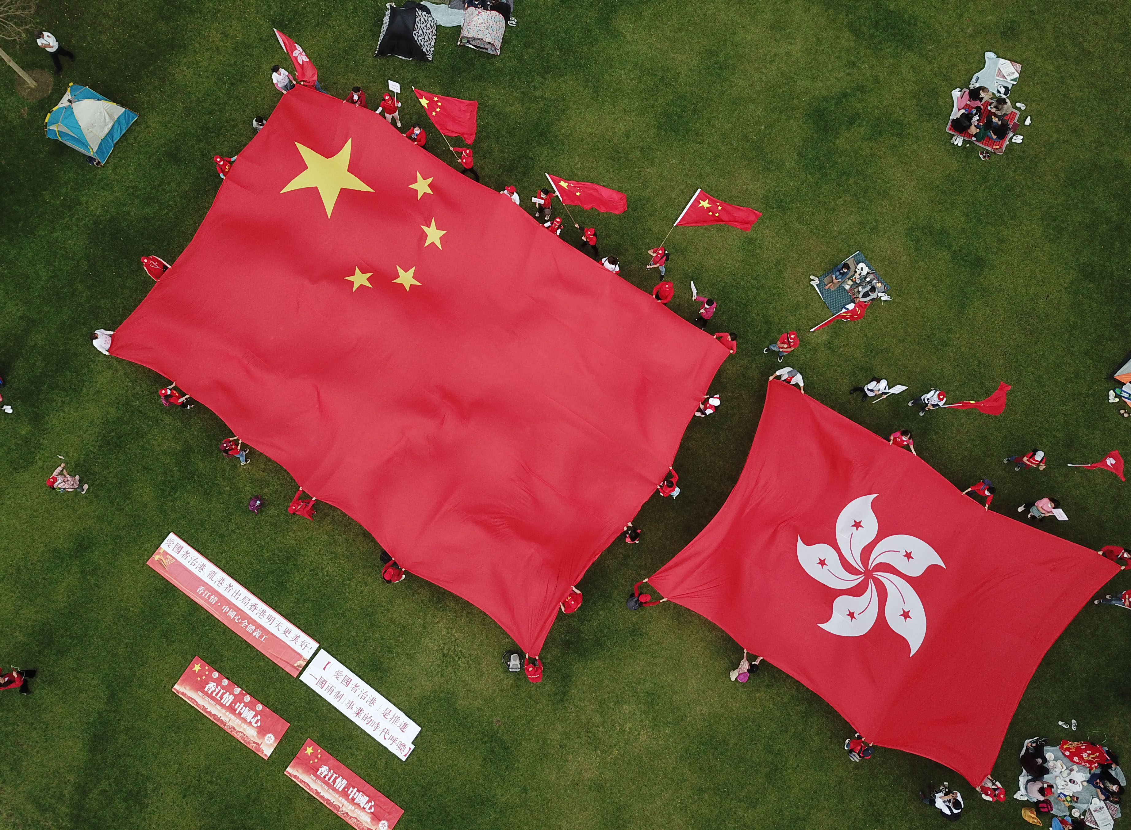 Hongkongers display the flags of China and Hong Kong in support of patriots governing Hong Kong, at Tamar Park on March 6. Photo: Xinhua