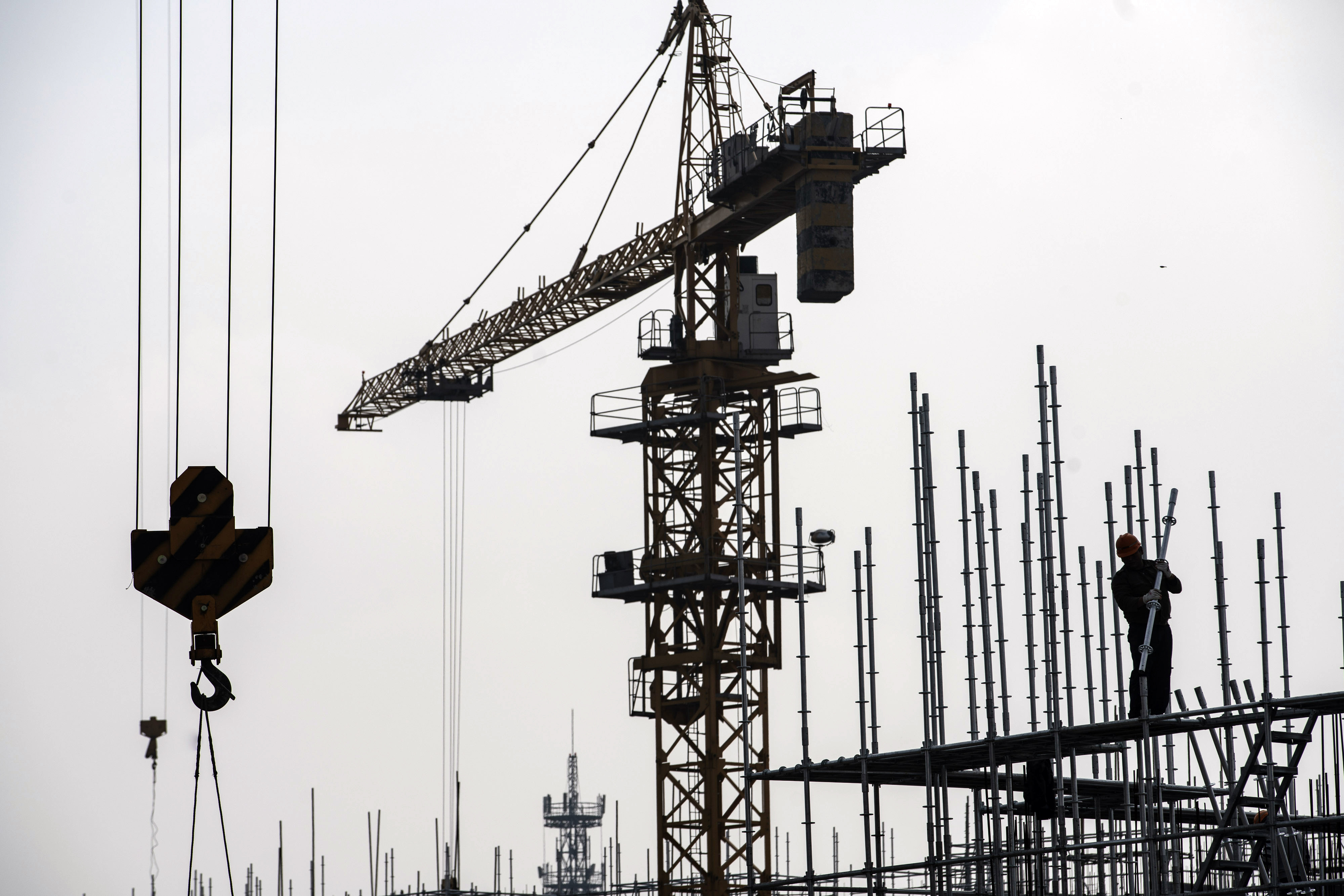 A worker stands near a crane at a construction site for a residential development on the outskirts of Shanghai, China, on March 14. China’s home prices grew at the fastest pace in six months in February. Photo: Bloomberg