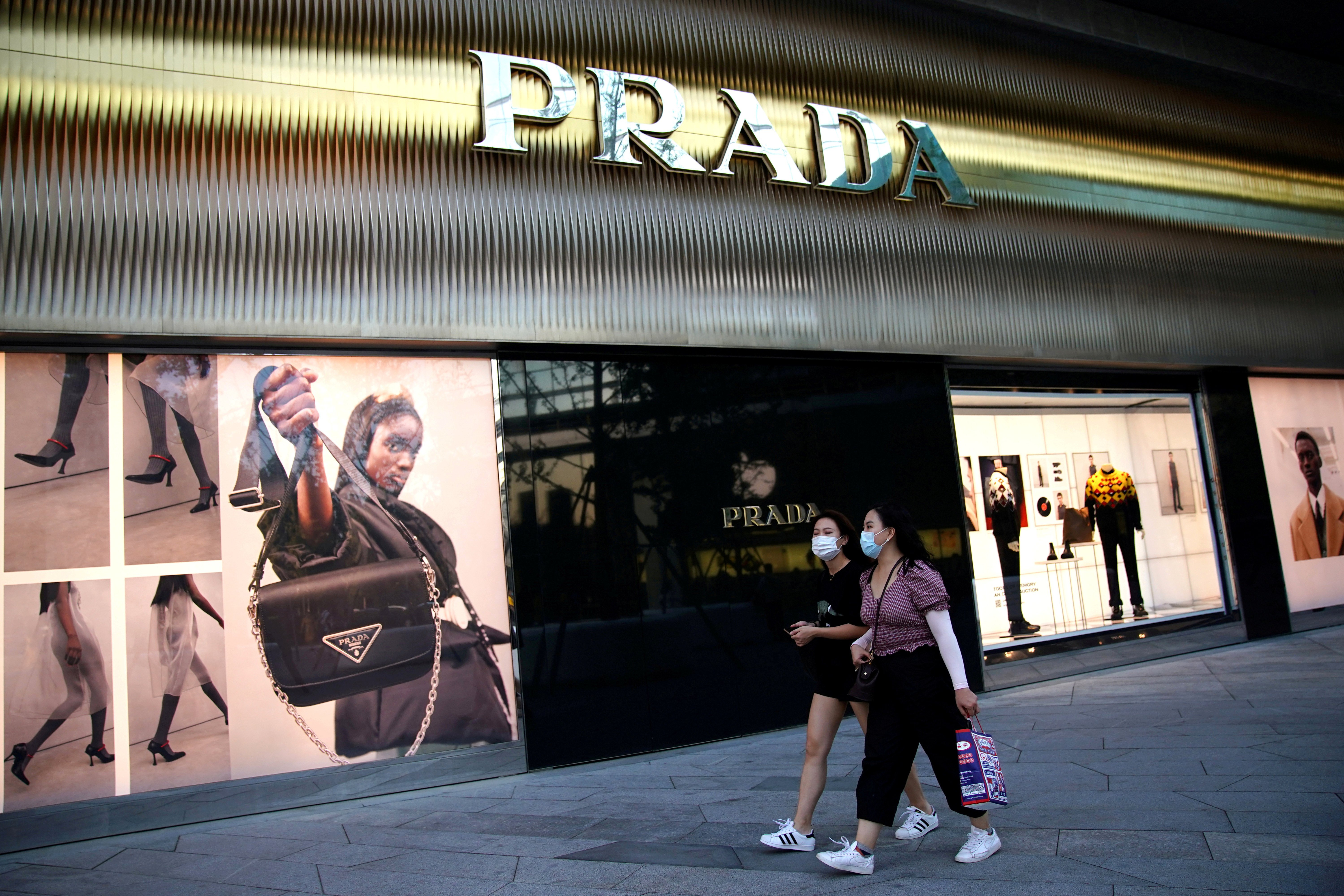 Shoppers walk past a Prada store at a shopping complex in Beijing.Chinese consumers have played a major role in the luxury market’s recovery in Asia Pacific.  Photo: Reuters