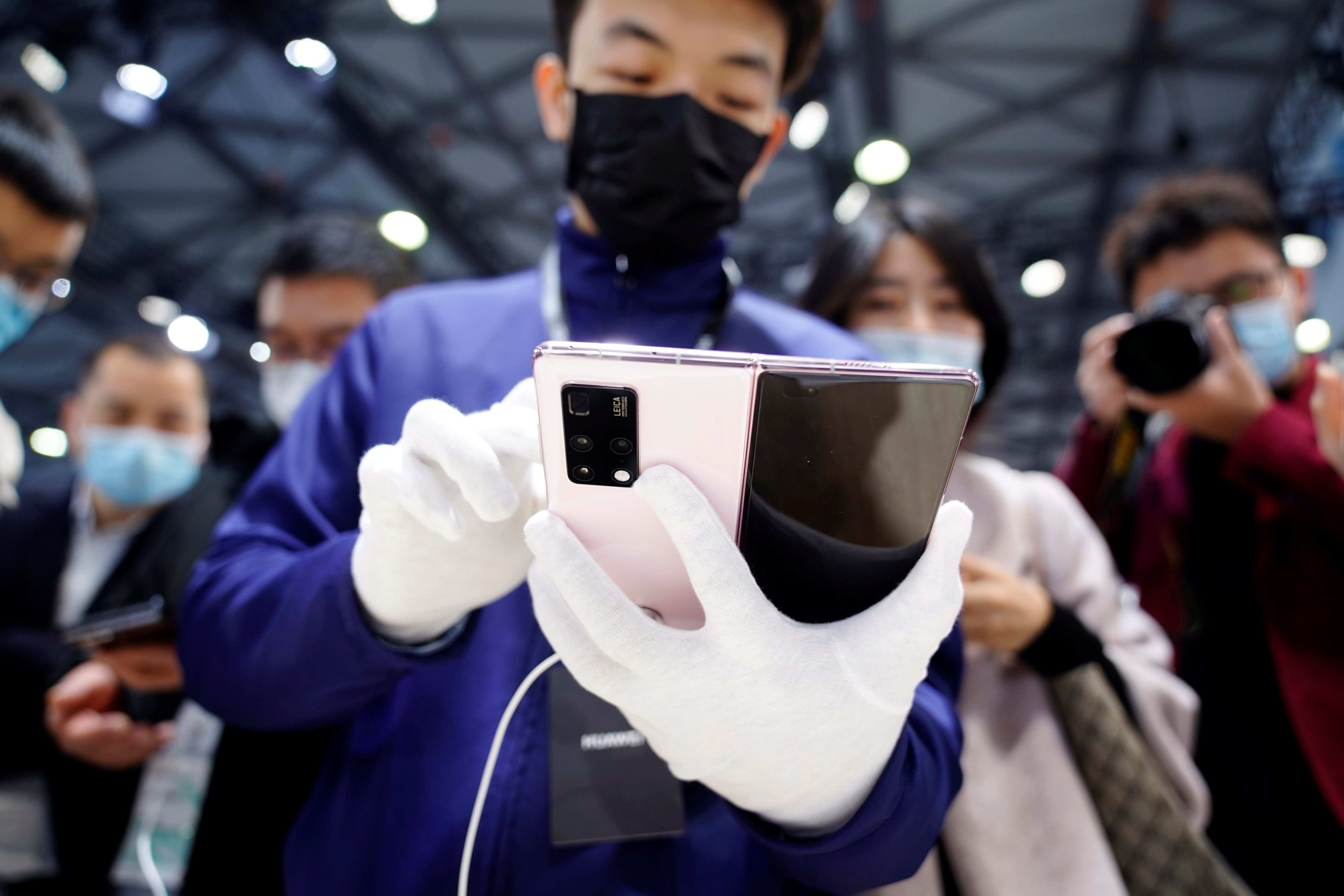 A staff member demonstrates Huawei’s new 5G Mate X2 foldable phone at the Mobile World Congress in Shanghai on February 23. Despite the US sanctions on Huawei, China will add 1 million 5G base stations this year. Photo: Reuters