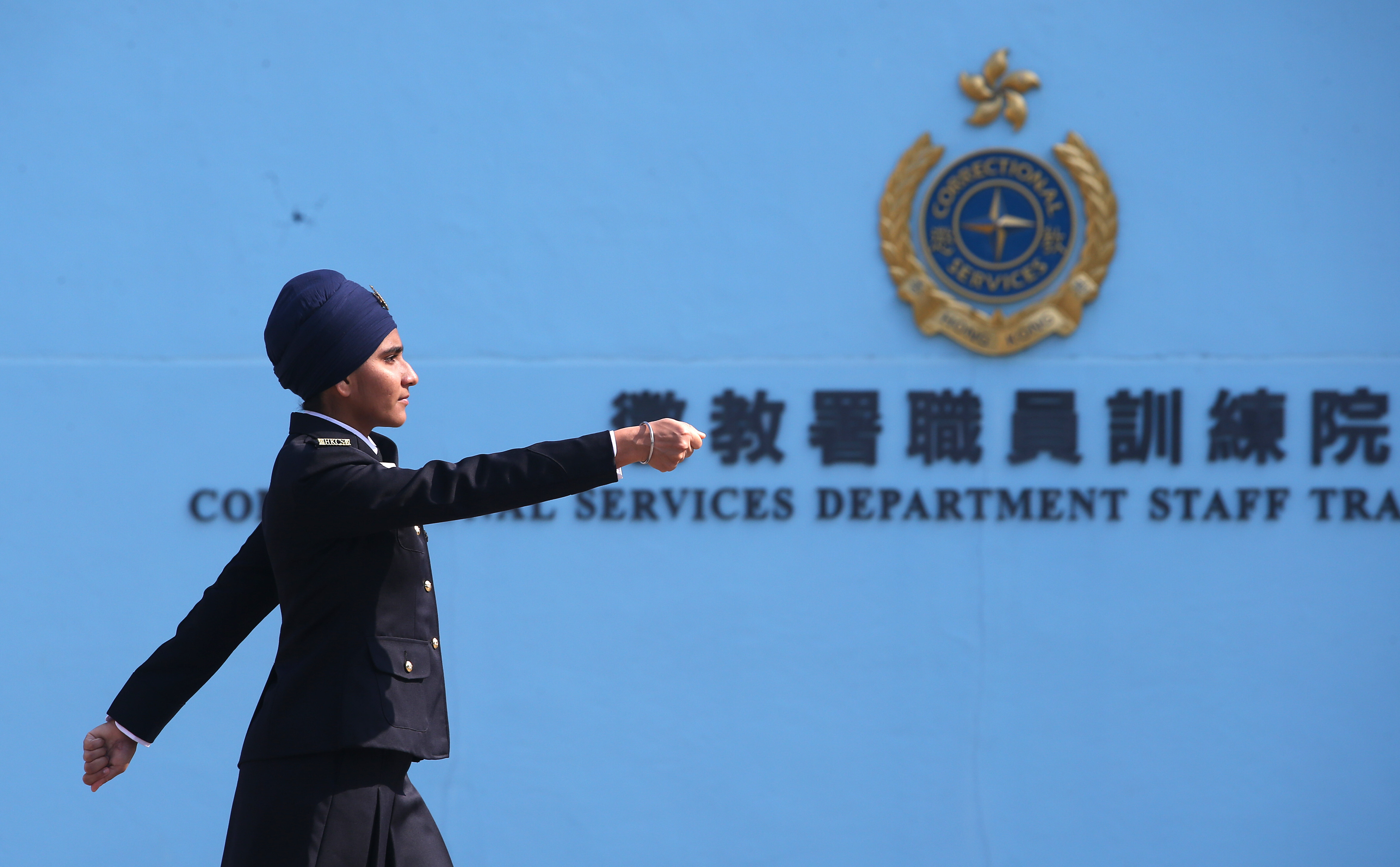 Sukhdeep Kaur, the first Sikh female prison officer to wear a turban in Hong Kong, marches in lockstep at the Hong Kong Correctional Services Department in Stanley on December 12, 2019. Attaining proficiency in the Chinese language has long been a challenge for members of Hong Kong’s ethnic minority communities. Photo: David Wong