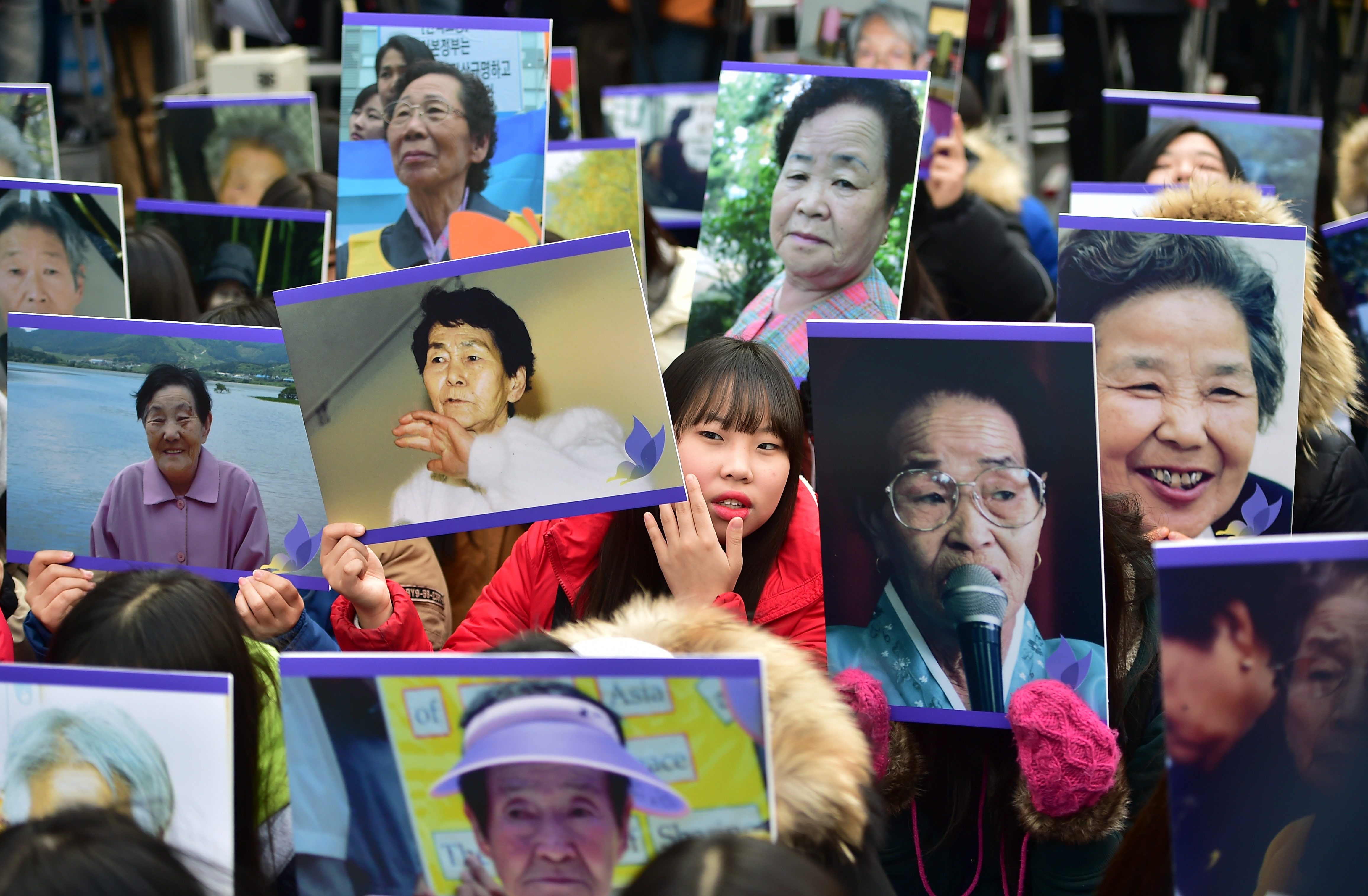 South Korean supporters hold portraits of former “comfort women”, who were coerced into working in brothels for Japanese soldiers during World War II, during a rally outside the Japanese embassy in Seoul in 2015. Photo: AFP