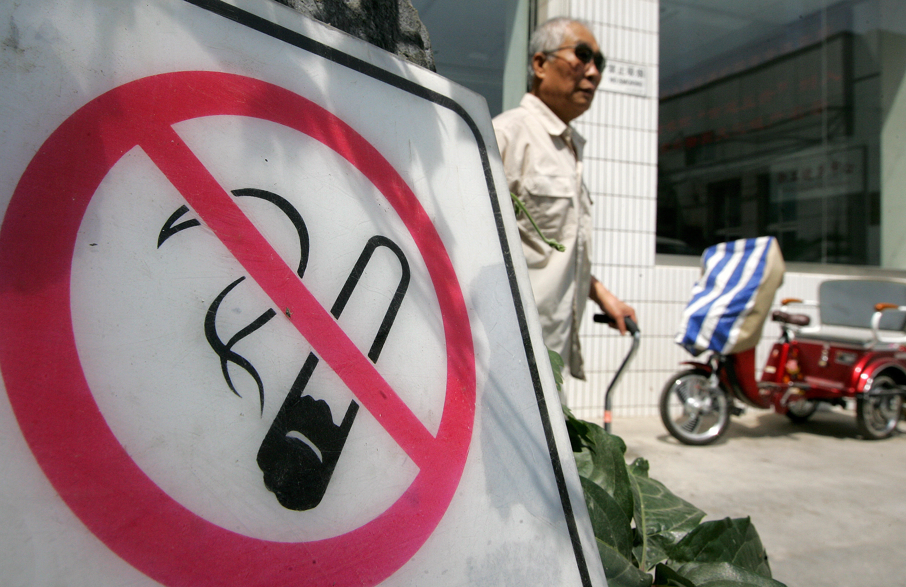 A man walks past a no smoking sign in Beijing. China, which has around 300 million smokers, is considered the world’s largest market for tobacco products. Photo: AFP