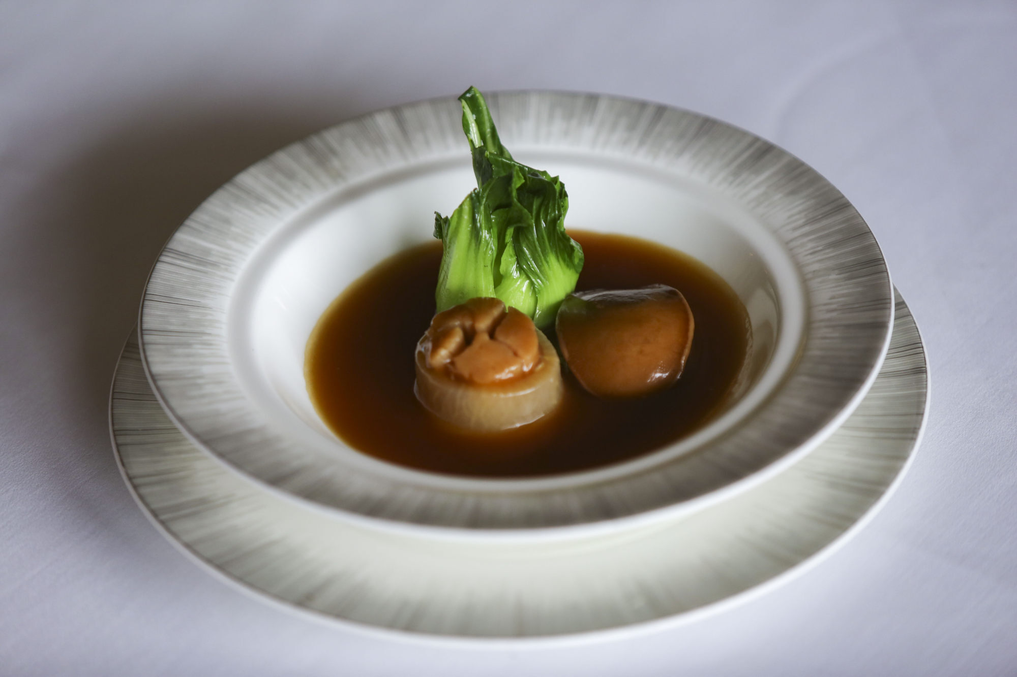 Braised whole abalone and stuffed conpoy in turnip. Photo: Chen Xiaomei
