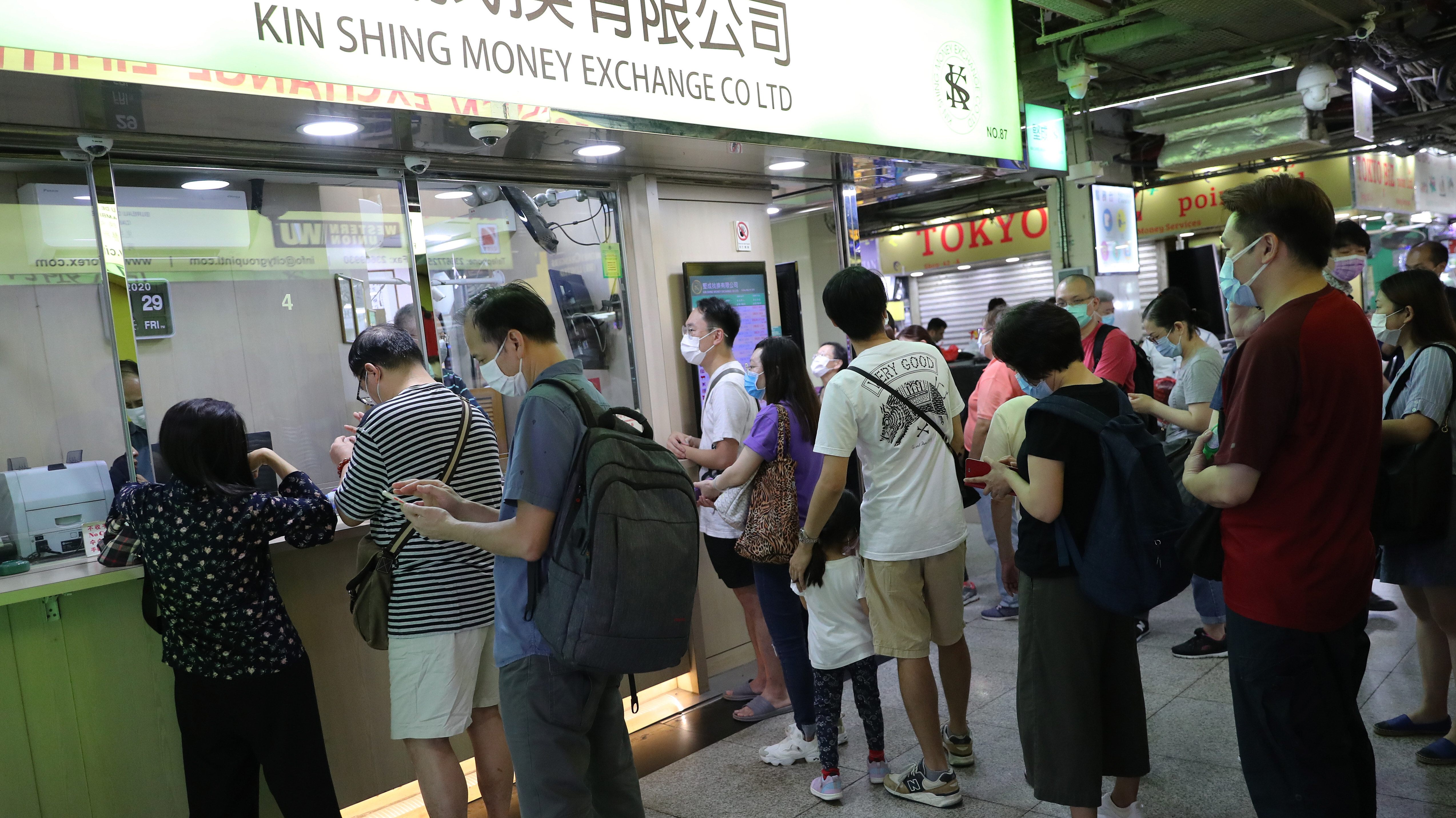 People queue to exchange Hong Kong dollars for foreign currencies at the Chungking Mansions in Tsim Sha Tsui, Hong Kong on May 29, 2020. Photo: Edmond So