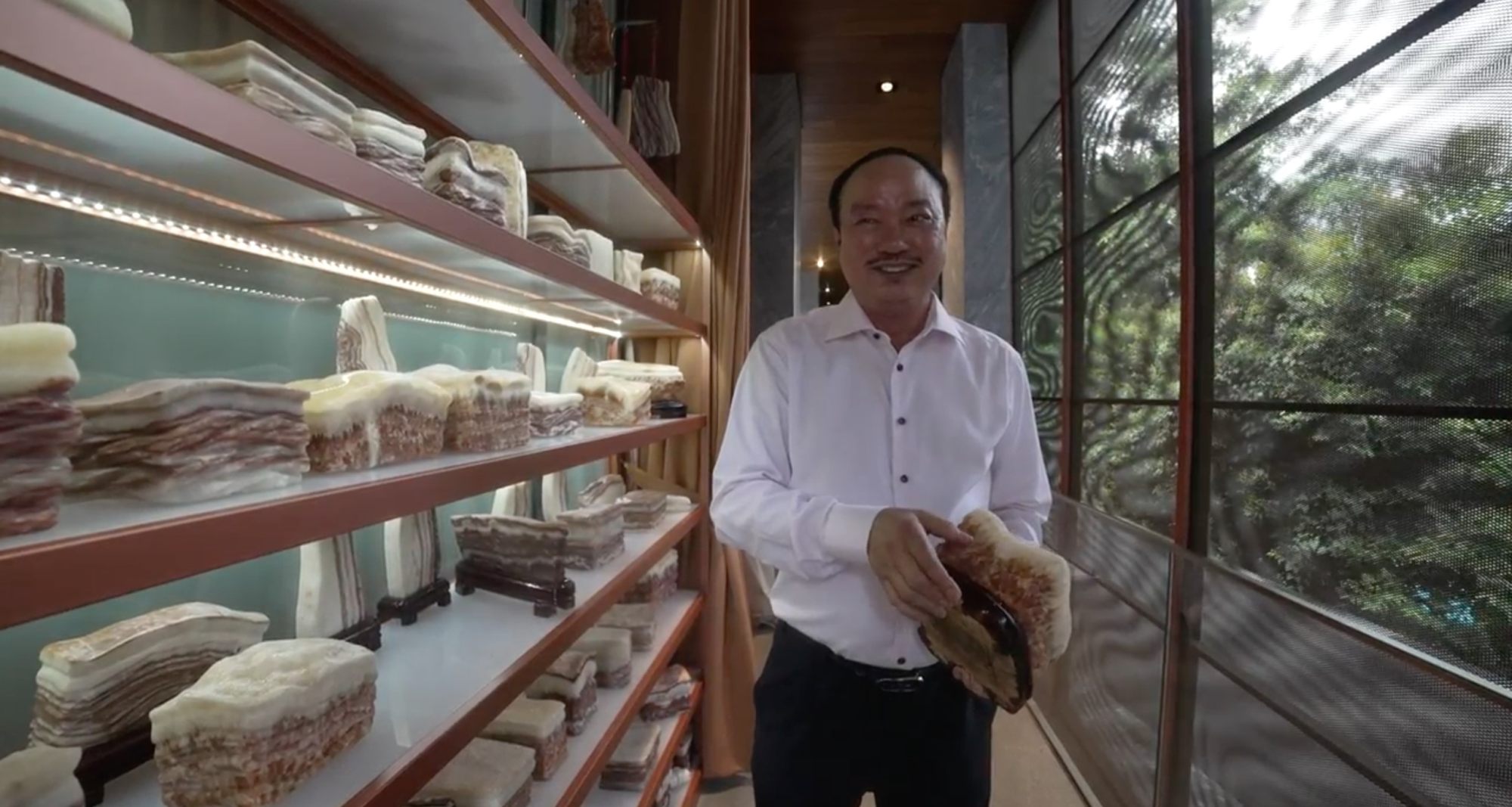 Lim Hock Leng holding on to what he calls “pork stones” that he brought back from Hubei province in China. He uses them as gifts for guests and also hangs a slab in front of all the pork stalls at Sheng Siong outlets. Photo: SCMP Pictures