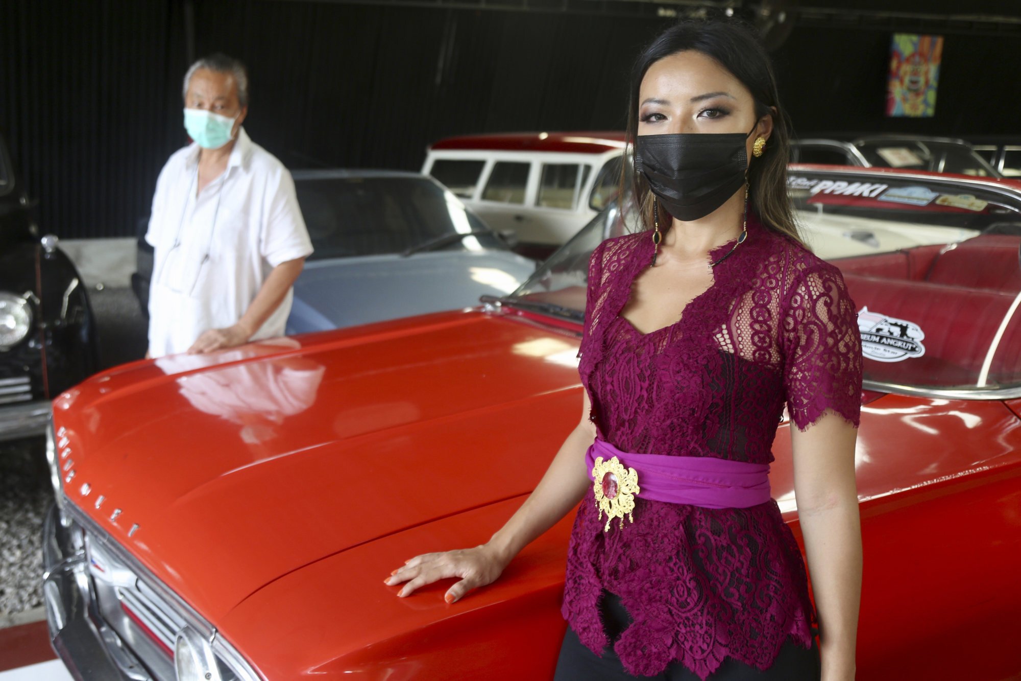 Jos Dharmawan (left) and his daughter Christia with an Impala 60 cabriolet at their car museum in Bali. Photo: Ian Neubauer