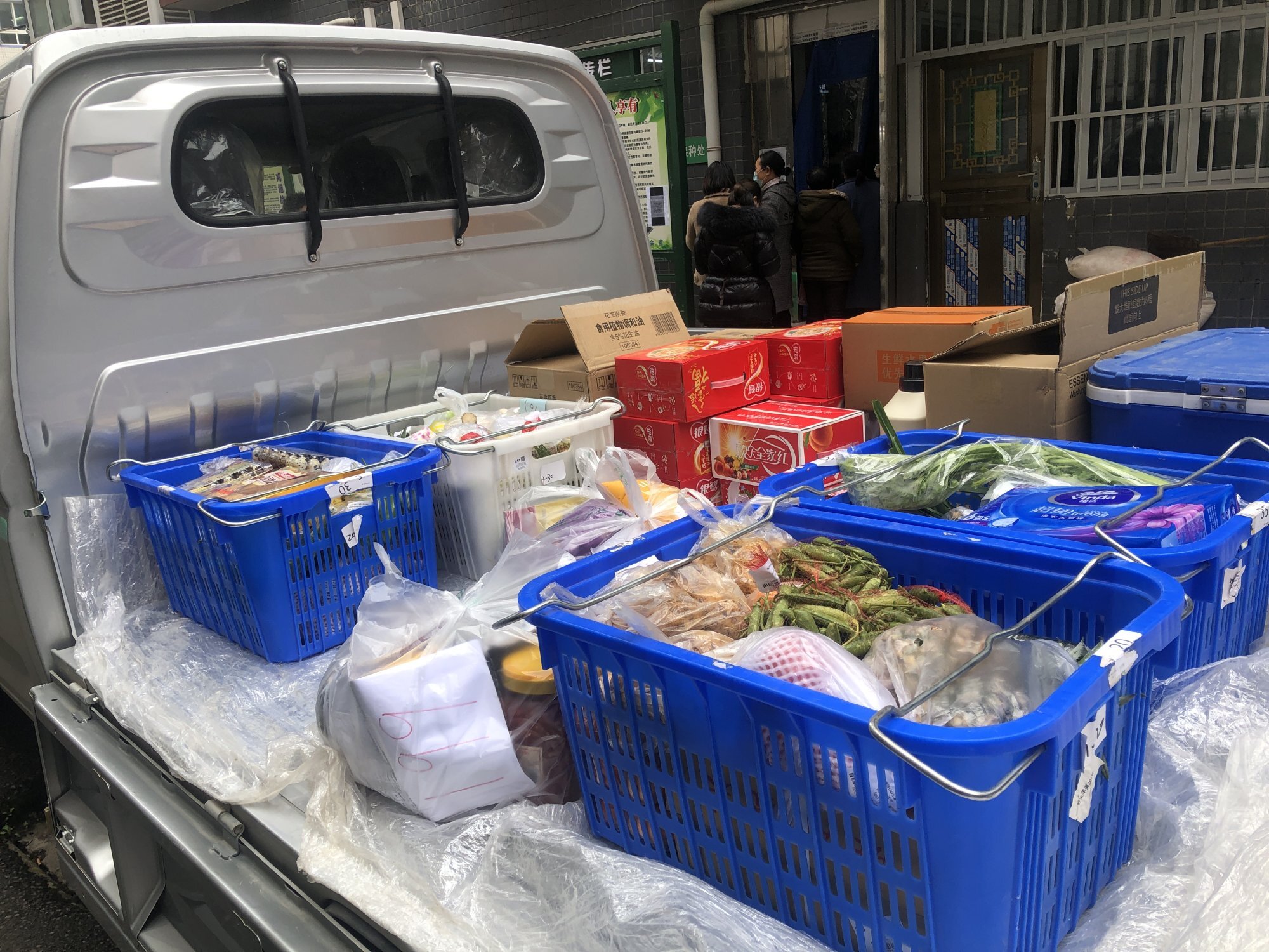 A delivery truck carries groceries and other products bought by residents at a community in Lichuan county, Hubei province, China. Photo: Jane Zhang