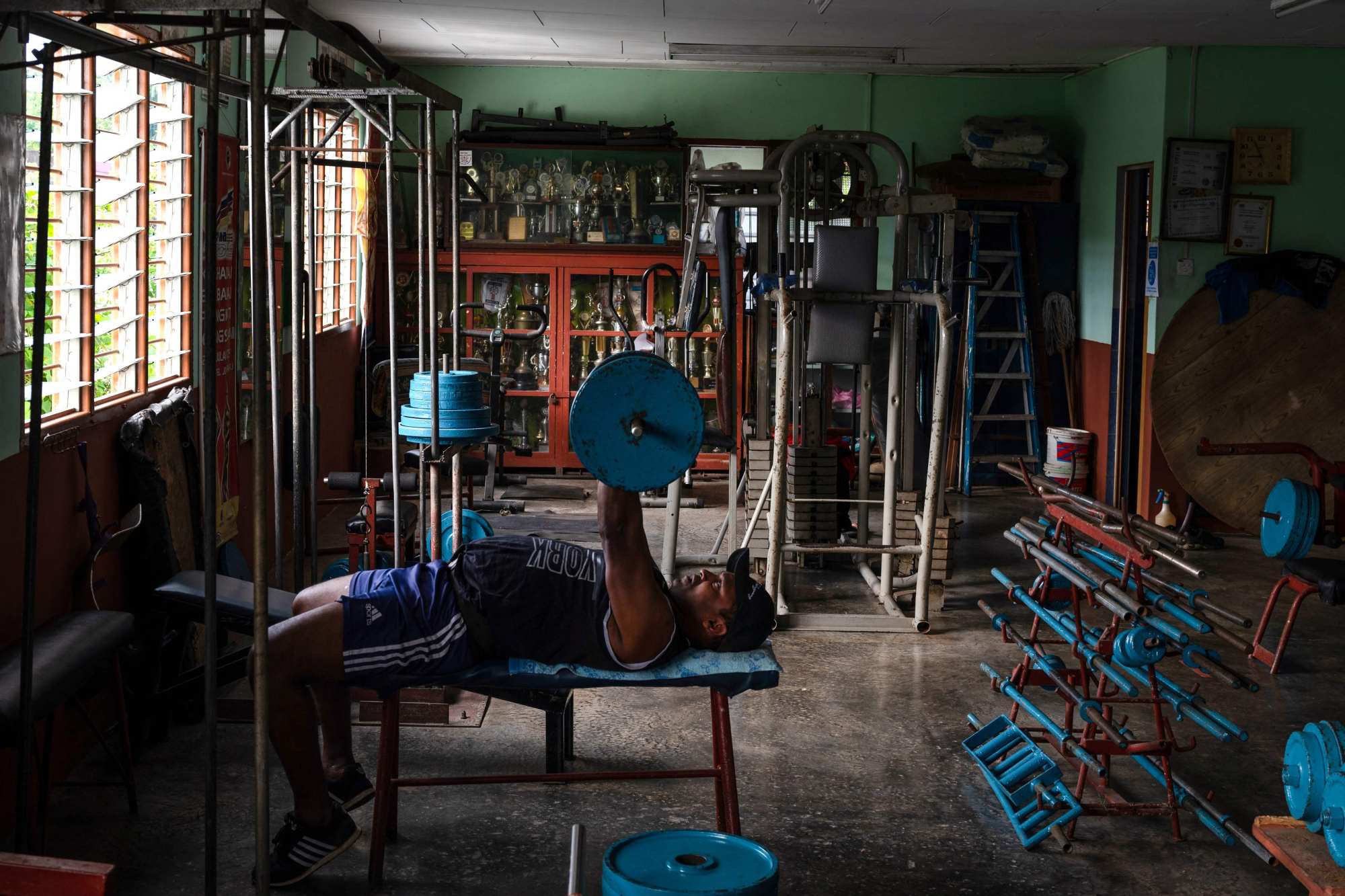 Arokiasamy’s gym is filled with weights of all sizes and constantly has men pumping iron. Photo: AFP