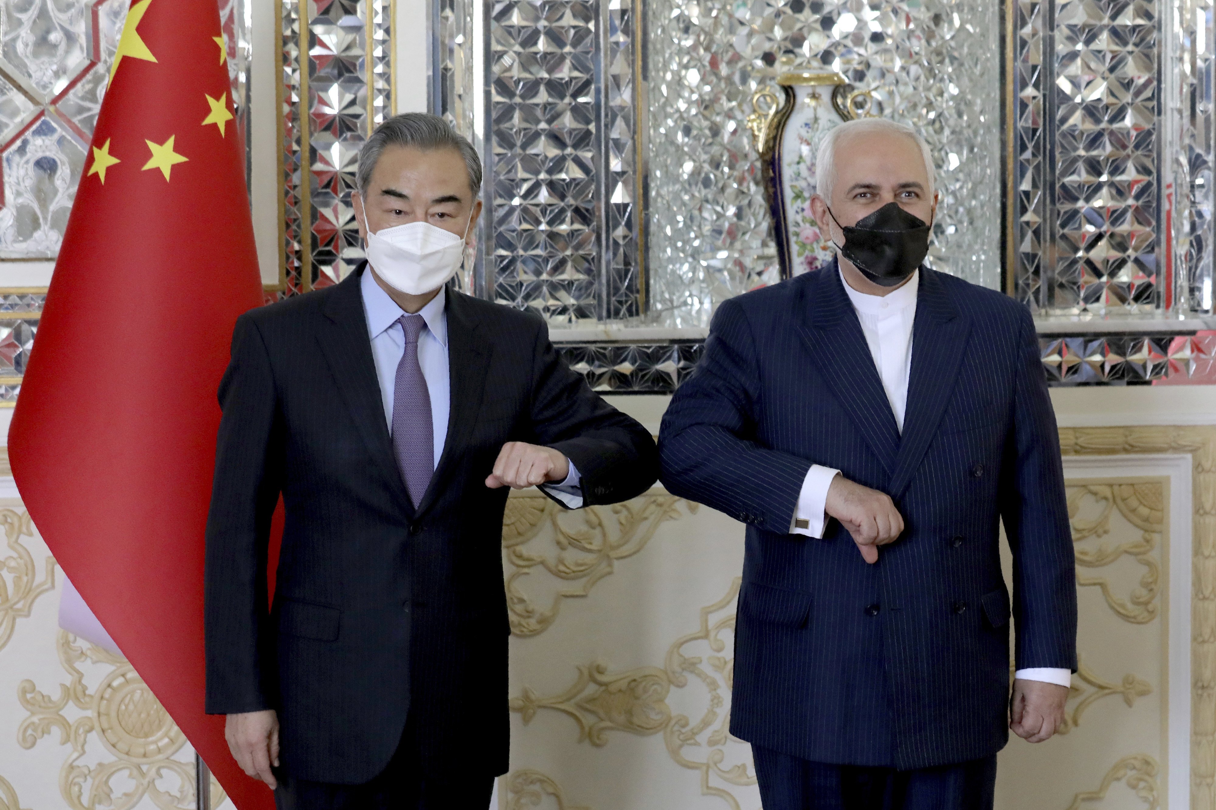 China’s Foreign Minister Wang Yi poses with his Iranian counterpart Mohammad Javad Zarif in Tehran on Saturday. Photo: AP