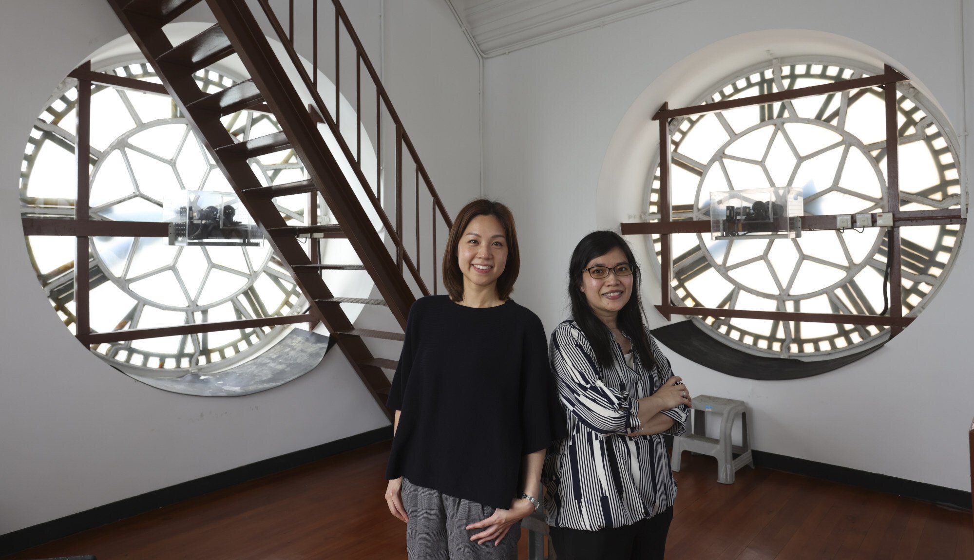 Karen Fung (left) and Christine Mok inside the clock tower. Both are representatives of the Antiquities and Monuments Office. Photo: Nora Tam