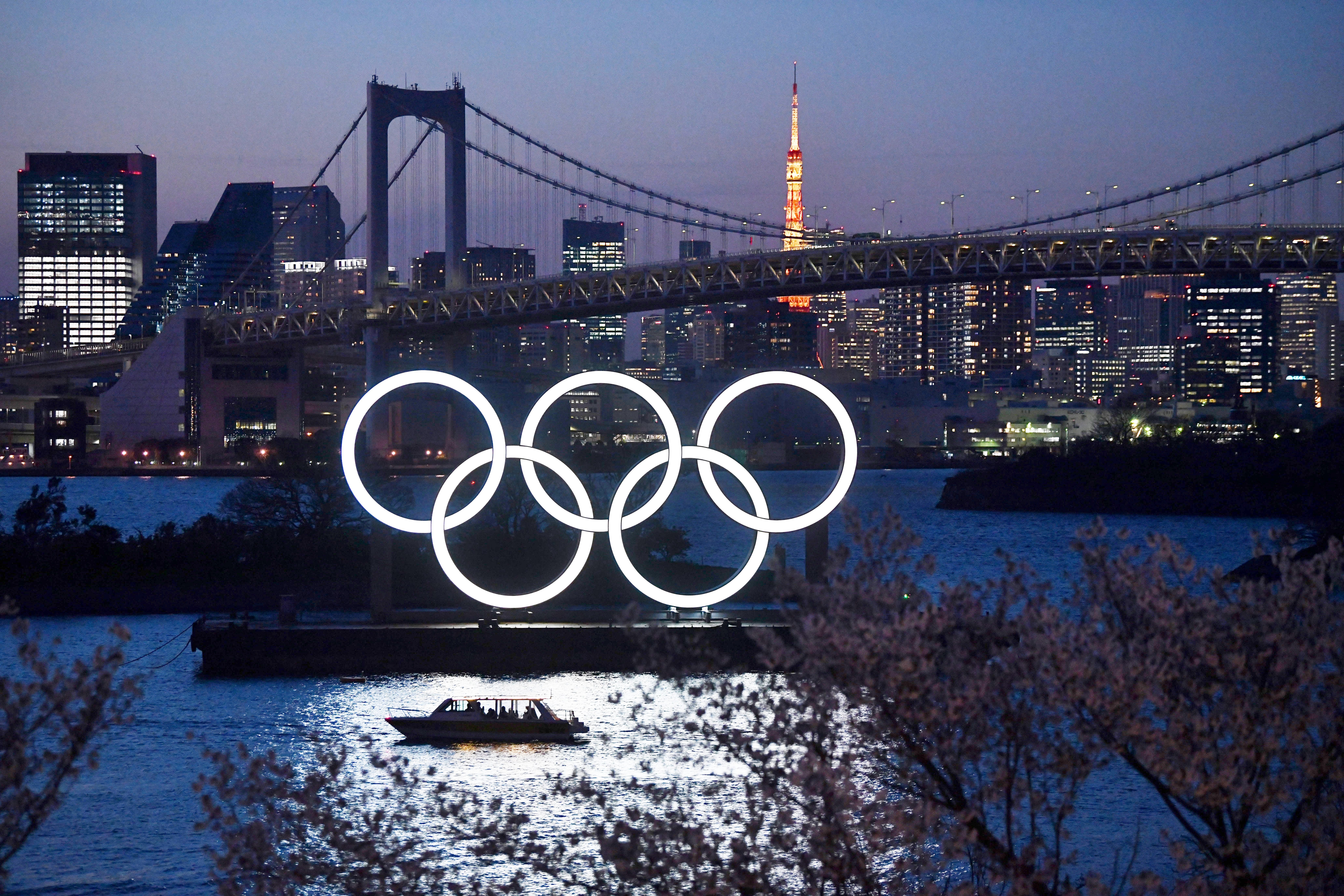 A boat sails past the Olympic rings in Tokyo on March 25. Photo: TNS