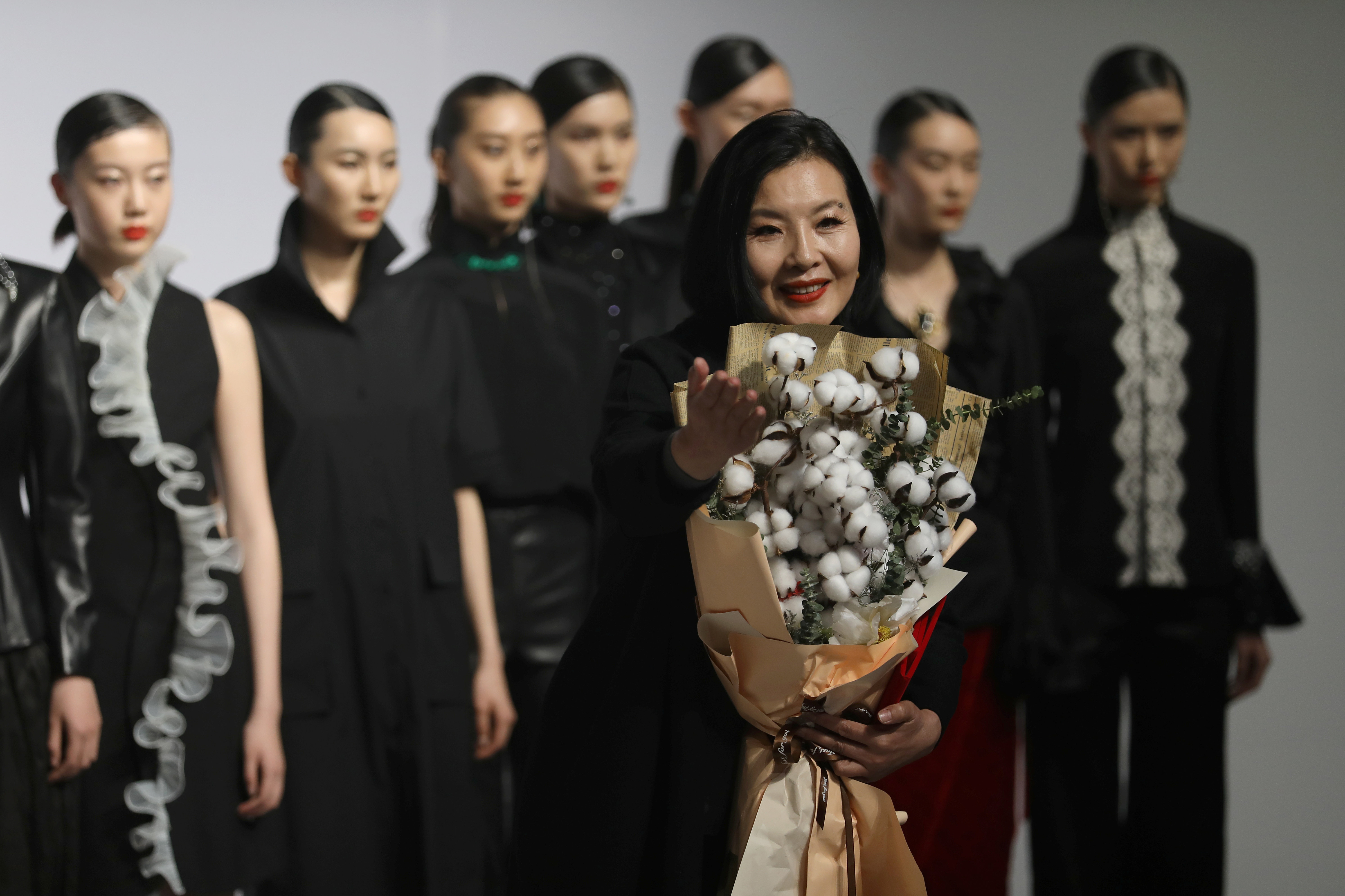 Designer Zhou Li holds a cotton bouquet after her autumn/winter 2021 collection show, during China Fashion Week in Beijing on March 30. Photo: Reuters
