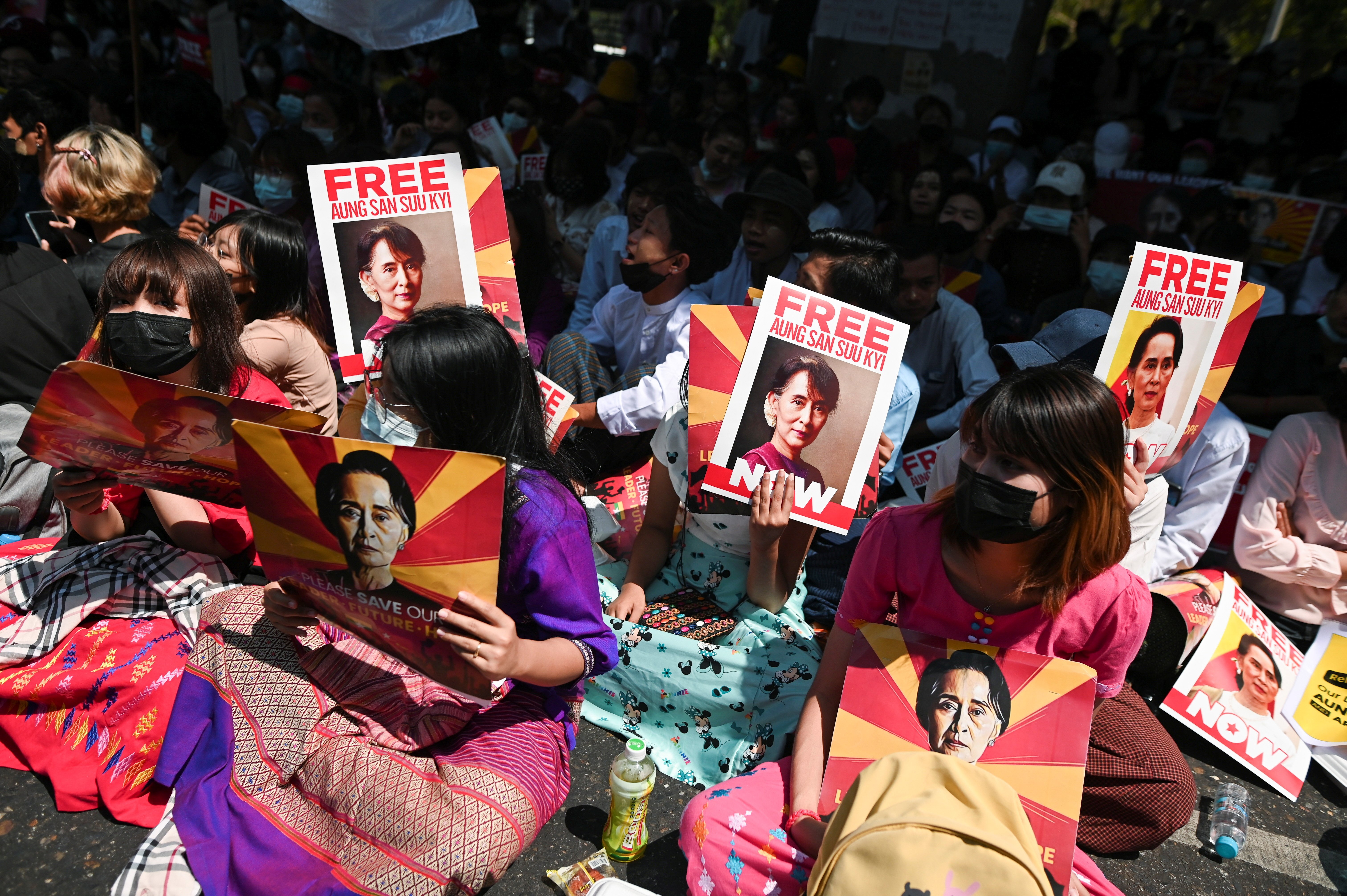 Factory workers hold placards as they rally against the military coup in Yangon in February. Photo: Reuters