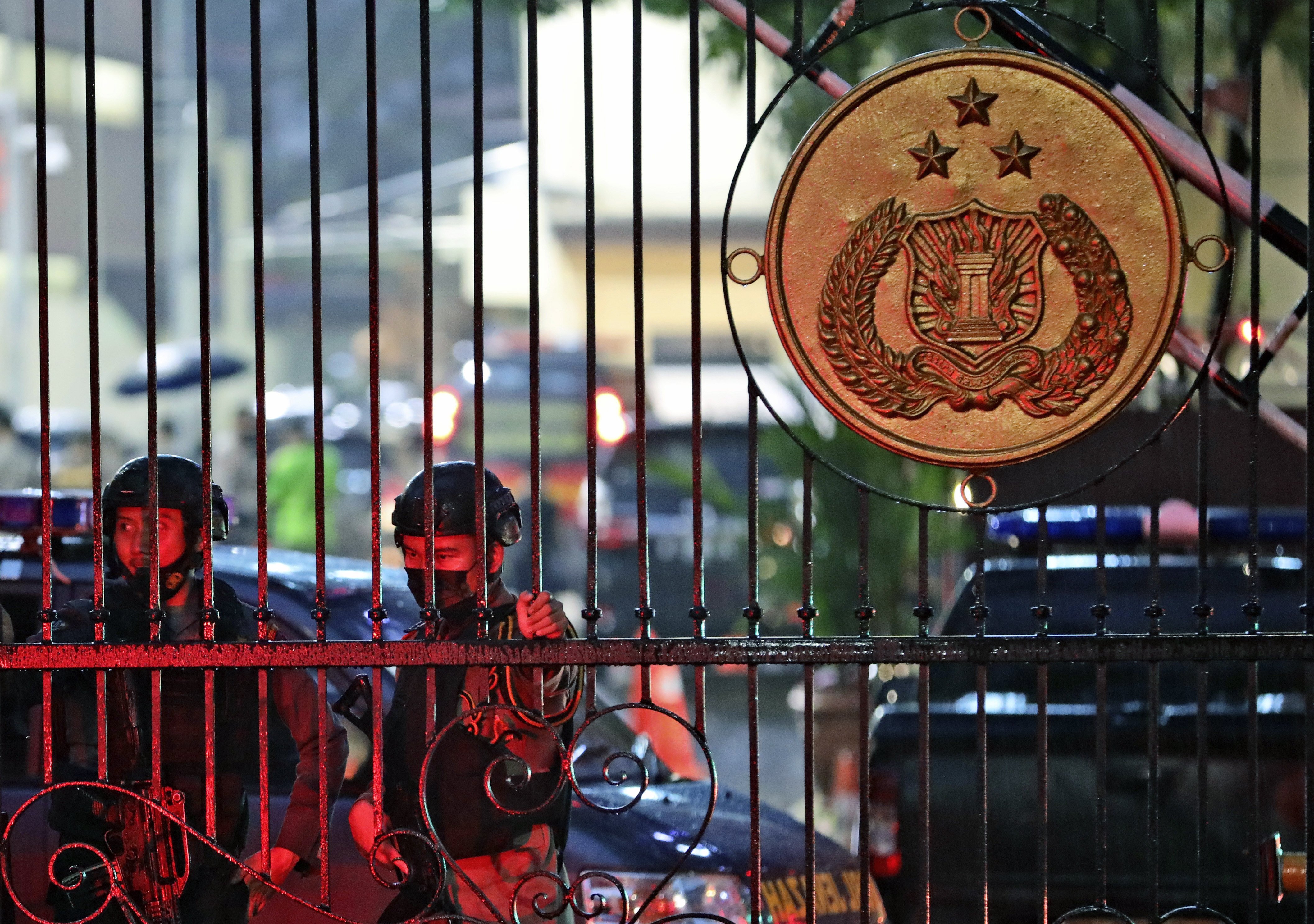 Police officers stand guard at the main gate of the National Police Headquarters in Jakarta following a suspected militant attack. Photo: AP