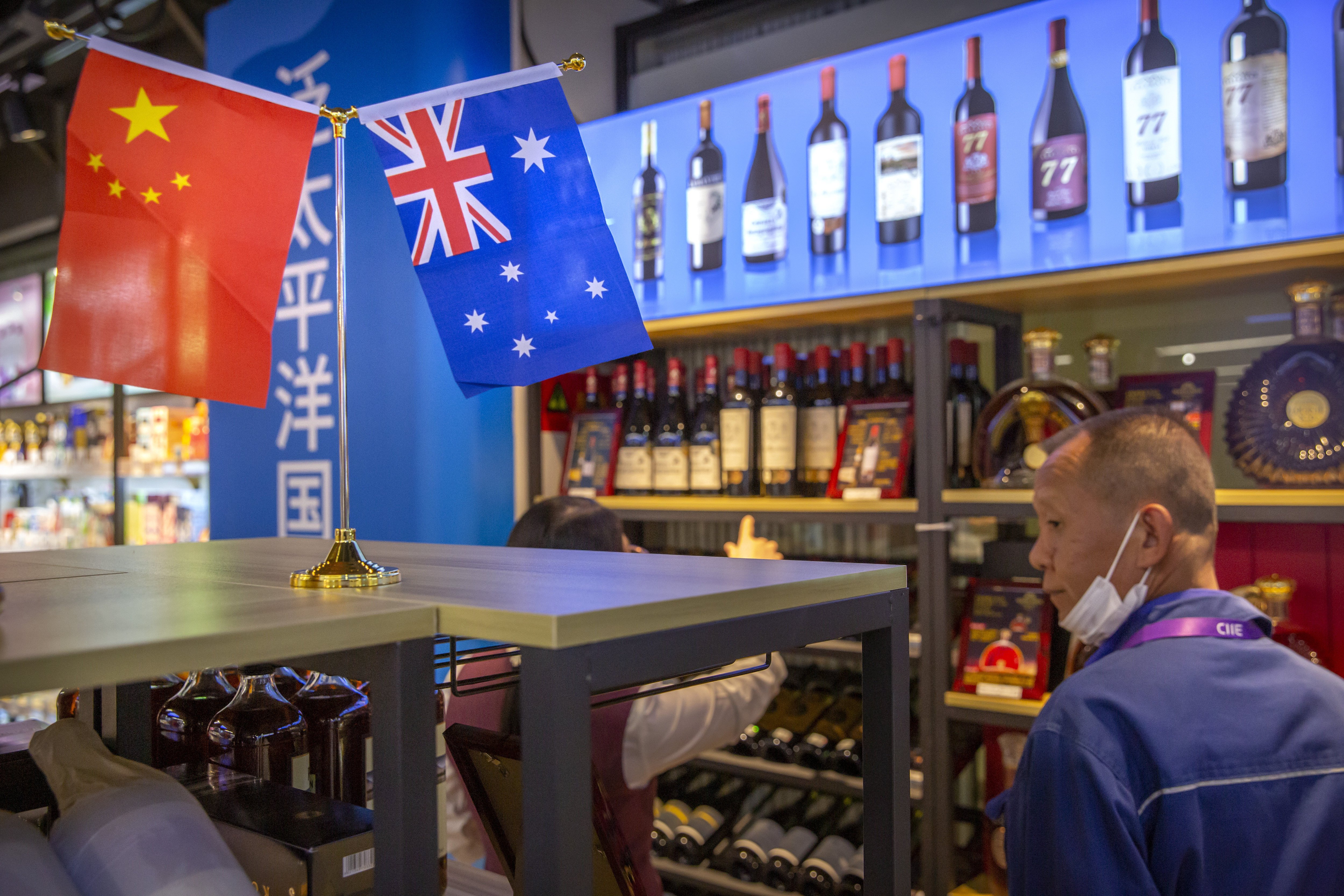 A visitor looks at a display of Australian wines at the China International Import Expo in Shanghai on November 5. Disputes over issues ranging from Xinjaing to 5G and Australia’s support for a probe into the origin of the coronavirus have sparked a trade spat and higher Chinese  import duties or outright bans on Australian products, including wine and coal. Photo: AP