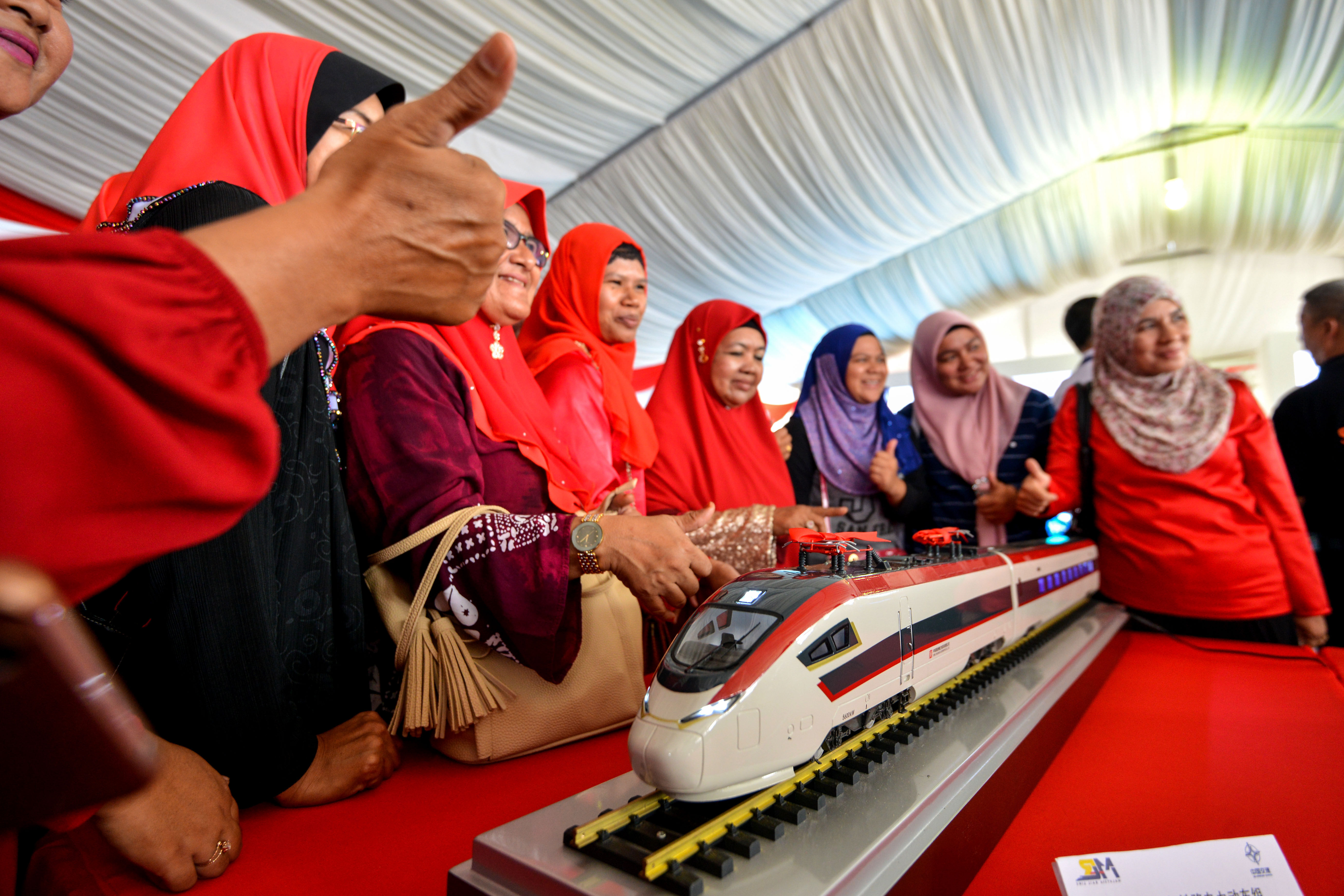 People pose with a train model of the East Coast Rail Link project during the 2017 ground breaking ceremony in Kuantan, Malaysia. File photo: Xinhua