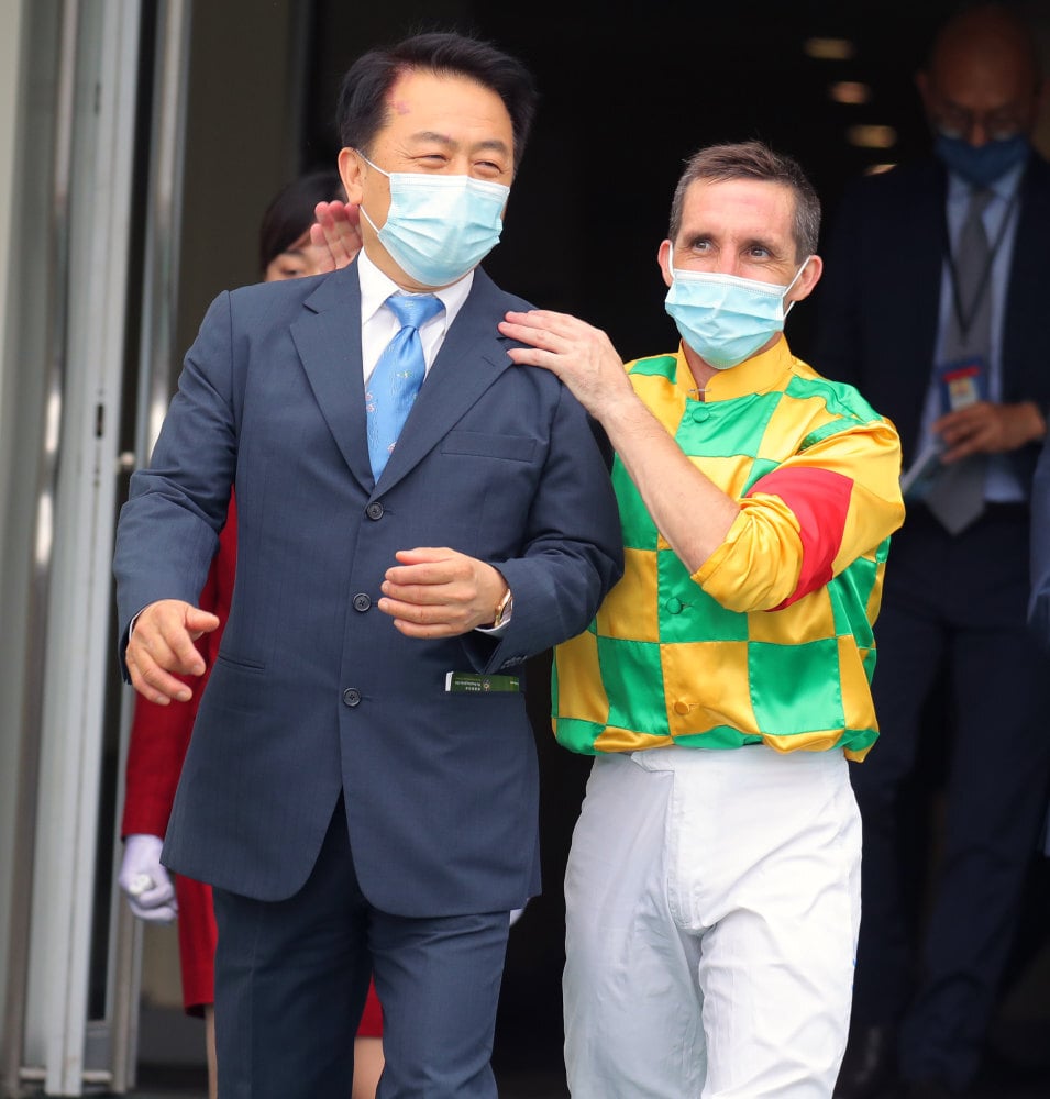 Trainer Ricky Yiu and jockey Neil Callan celebrate.