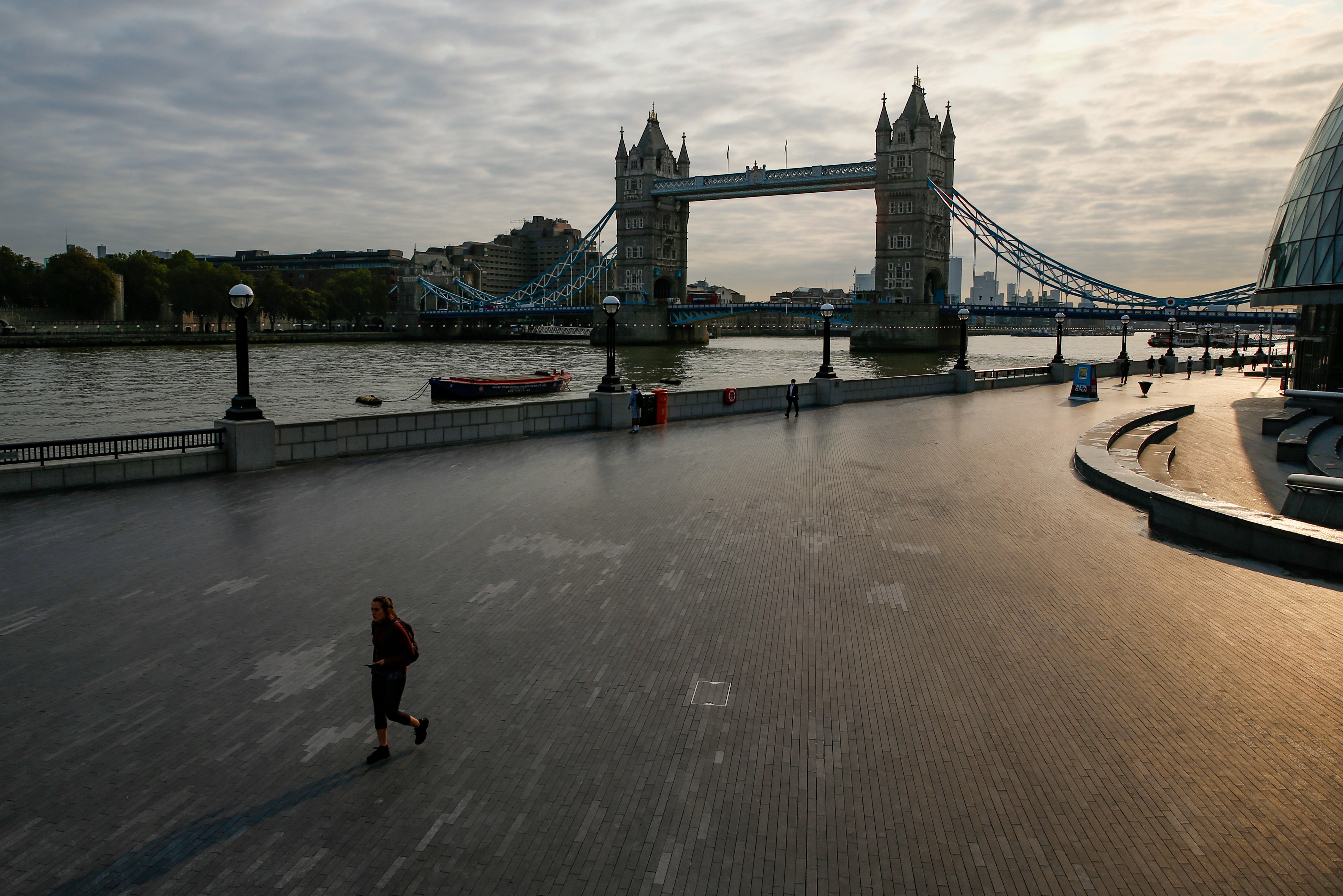 A commuter walks along the Thames Path in view of Tower Bridge in London in September 2020. Racist attitudes in the UK have often been intertwined with anti-immigration rhetoric. Photo: Bloomberg