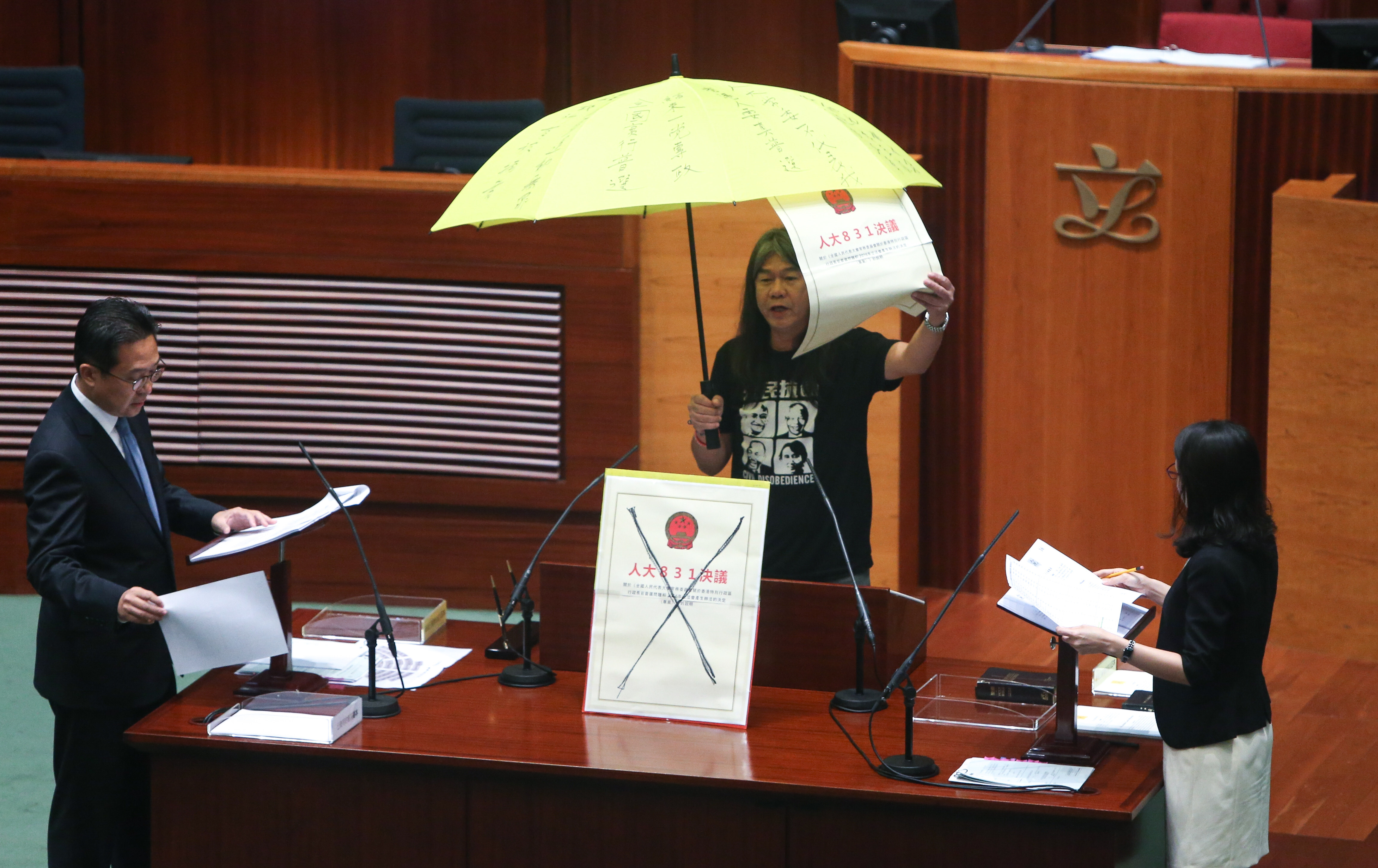 Moves such as raising an umbrella, carried out here by former legislator Leung Kwok-hung in 2016, during oath-taking is not acceptable, officials have warned. Photo: Dickson Lee