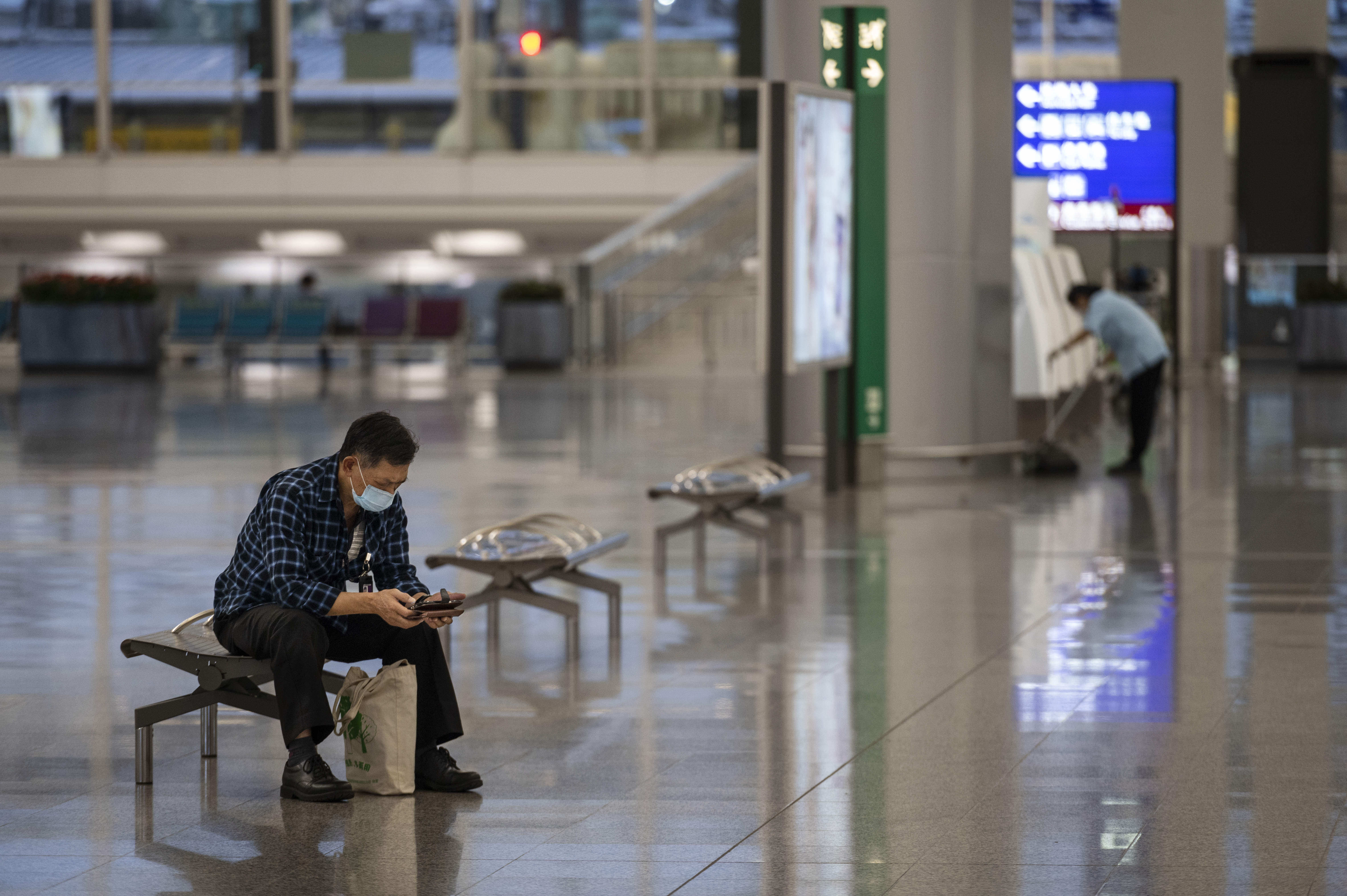 A passenger wearing a face mask waits at Hong Kong International Airport on October 24, 2020. Photo: CWH 