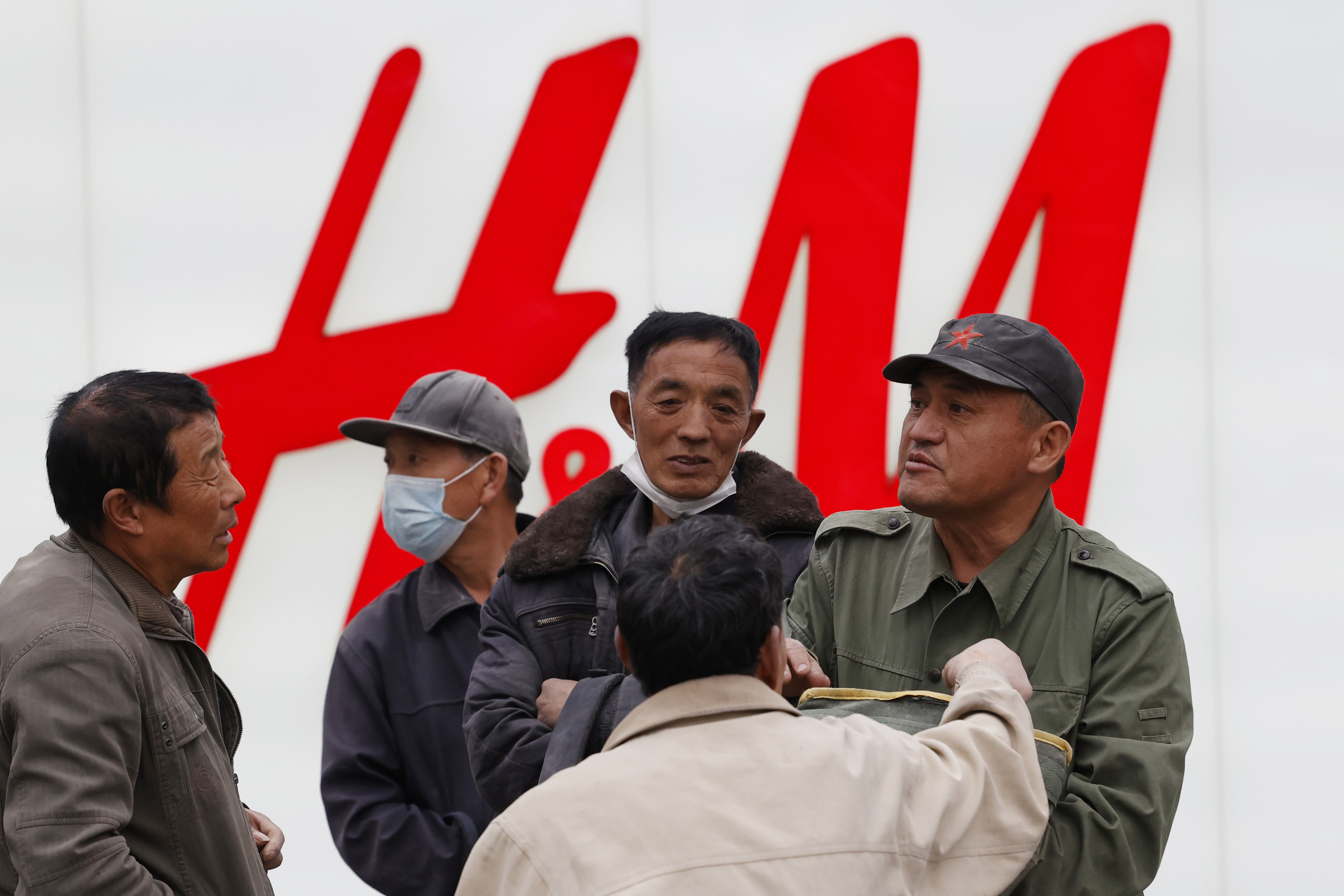 Men gather near an H&M store in Beijing on March 29. Photo: Associated Press