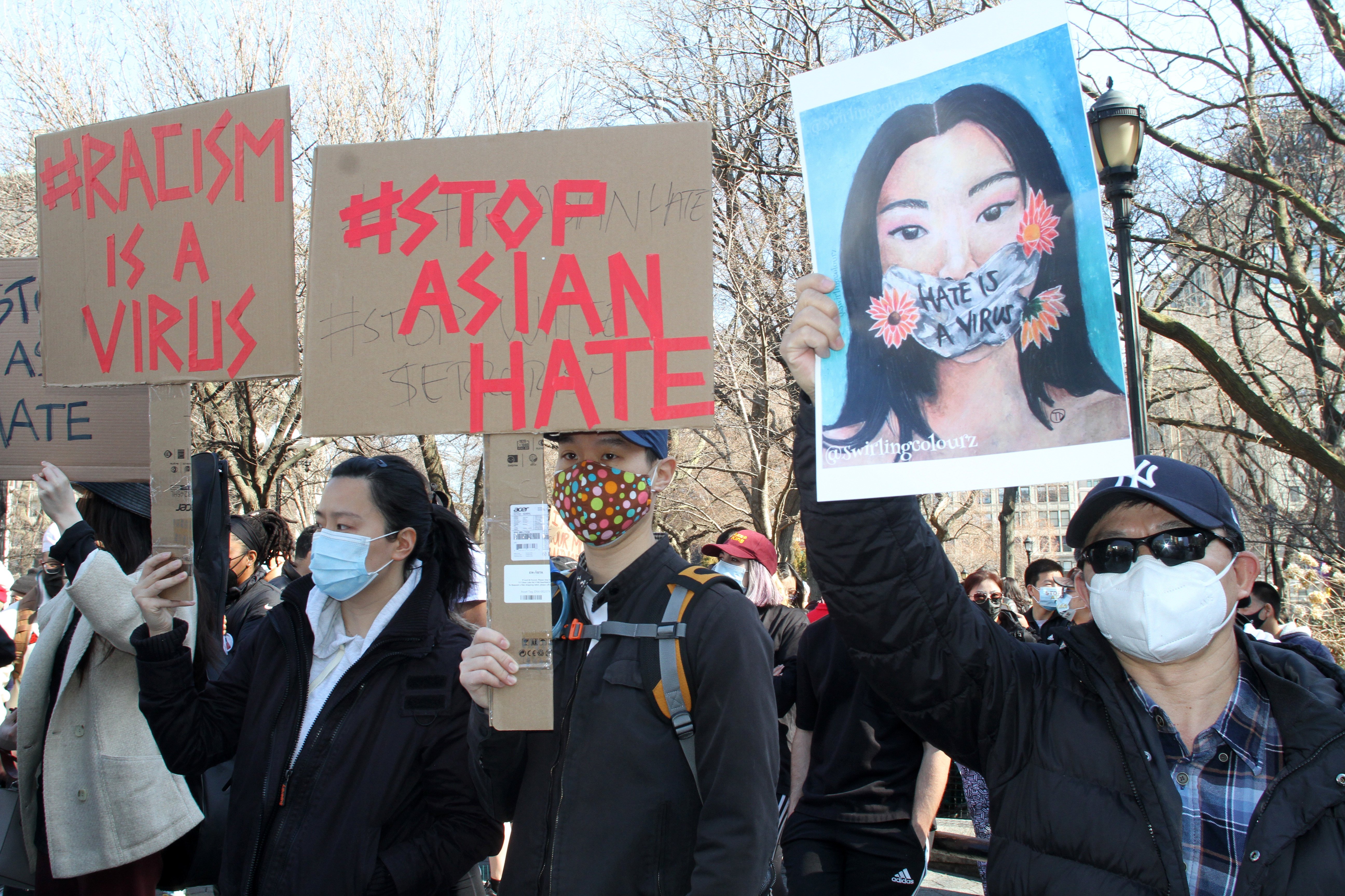 Members and supporters of the Asian-American community hold placards during a rally at Manhattan’s Union Square in New York on March 21. Photo: DPA