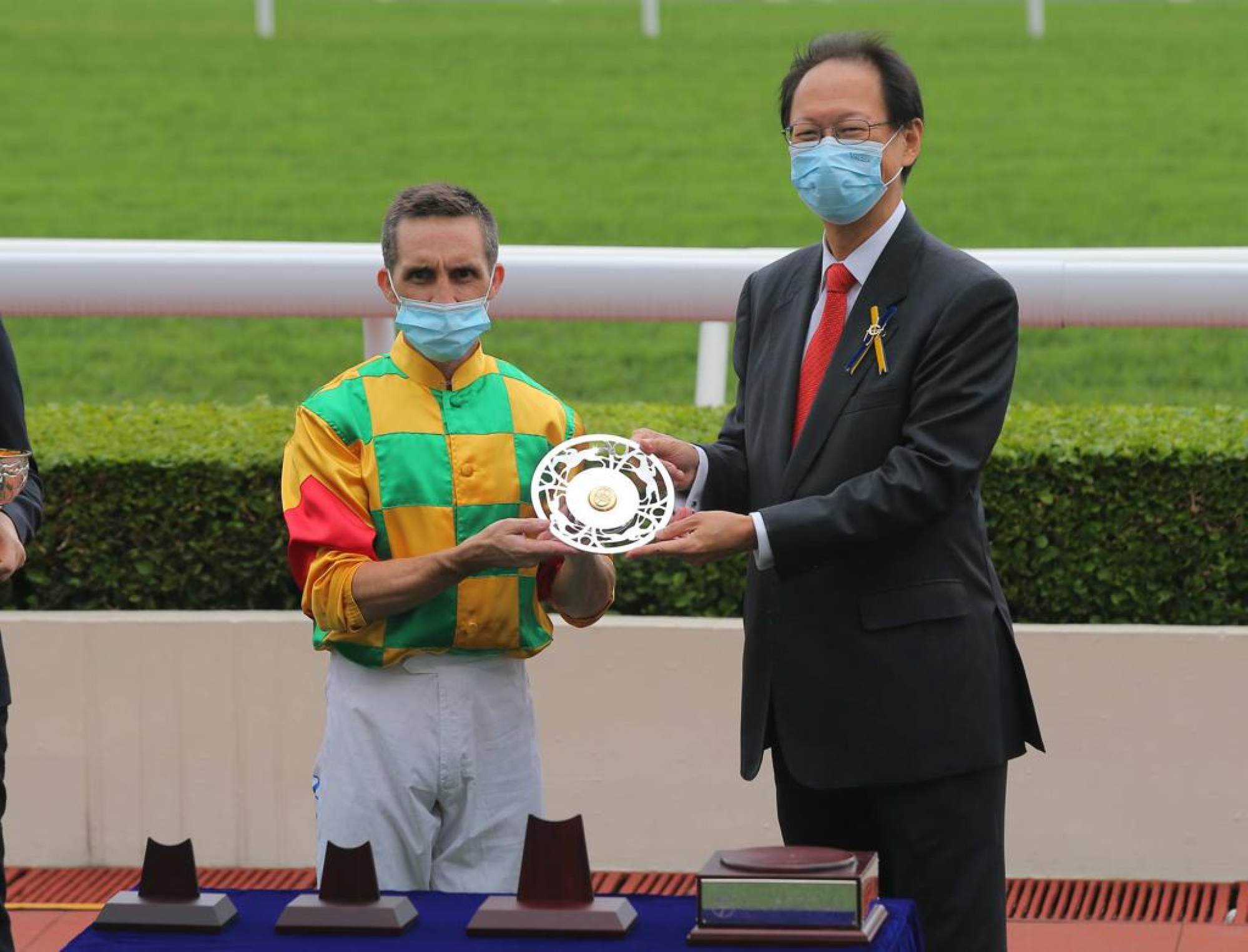 Jockey Club chairman Philip Chen presents Neil Callan with his prize for winning the Chairman’s Trophy with Mighty Giant on Monday.
