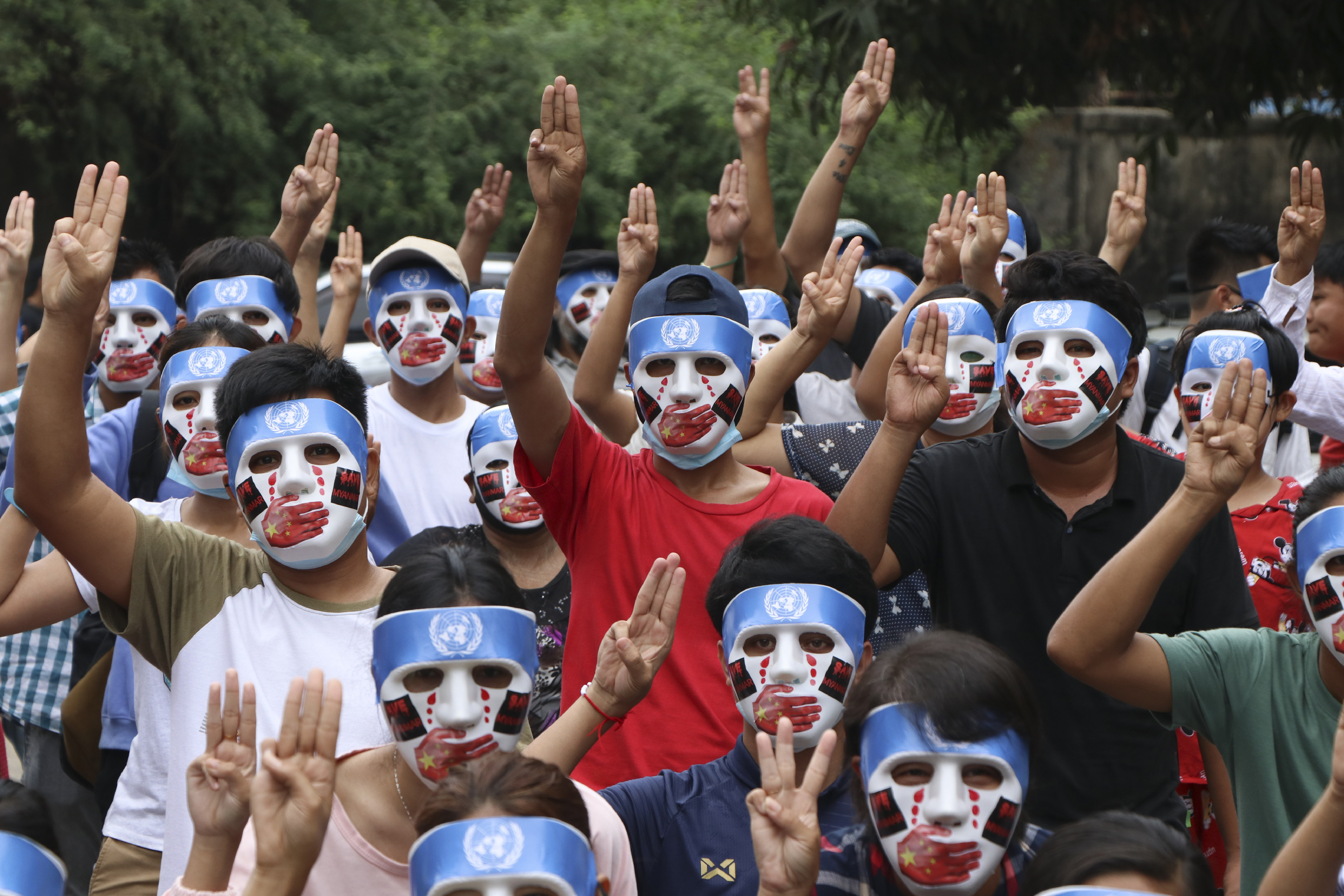 Demonstrators flash the three-finger salute during an anti-coup mask strike in Yangon on April 4. Photo: AP