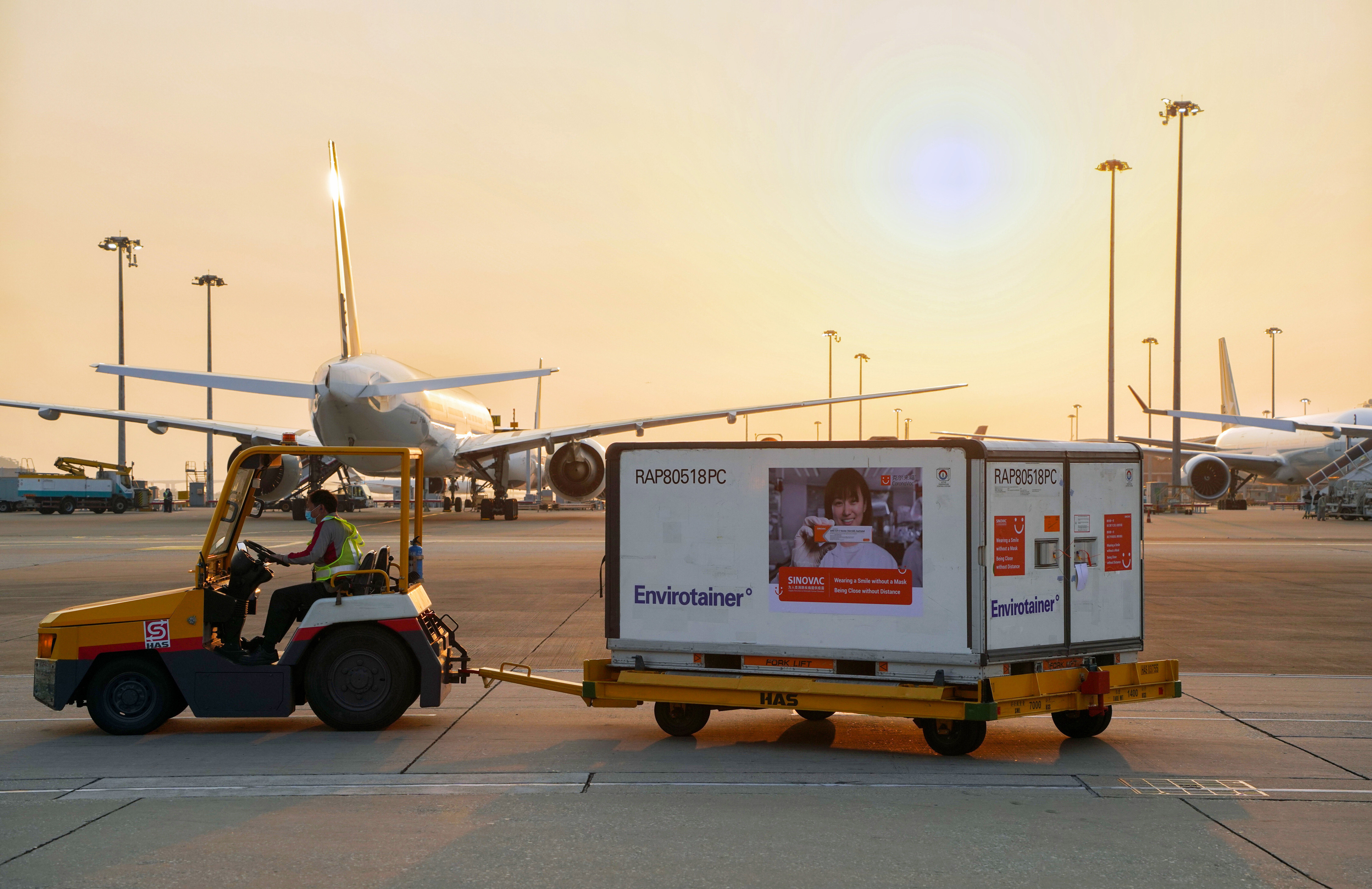 Containers carrying Sinovac’s Covid-19 vaccine are unloaded from a Cathay Pacific plane at the Hong Kong International Airport on February 19. Photo: Handout