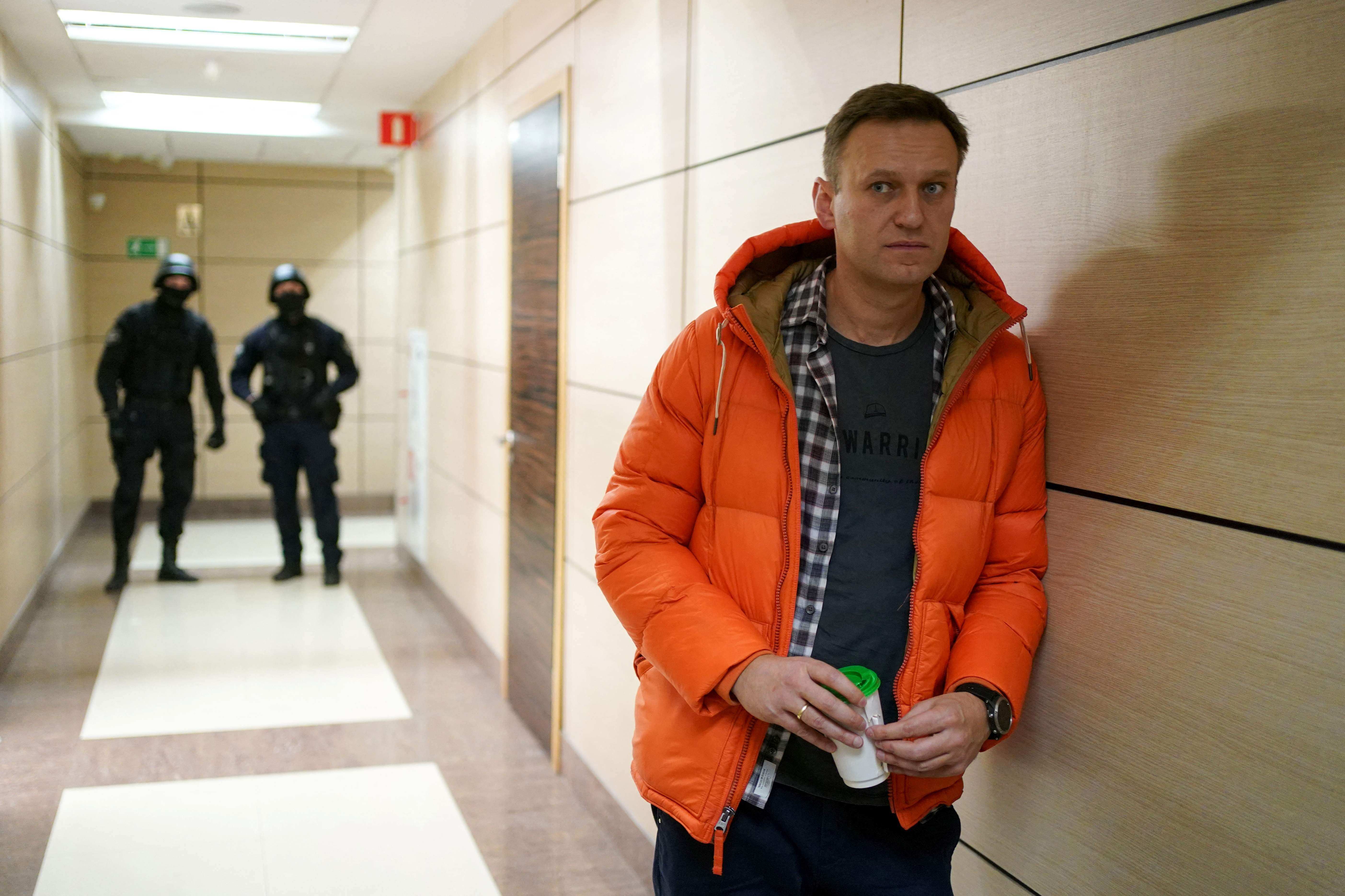 Russian opposition leader Alexei Navalny stands near law enforcement agents in a business centre that houses the office of his Anti-Corruption Foundation in Moscow in December 2019. Photo: AFP