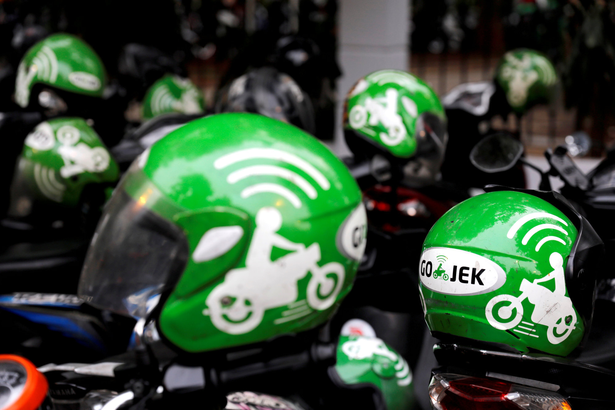 Gojek driver helmets are seen in Jakarta, Indonesia. Photo: Reuters