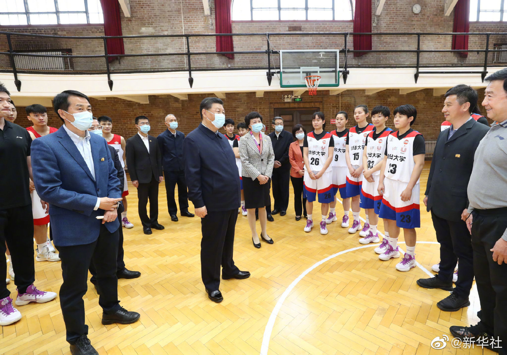 Xi meets a basketball team during his visit. Photo: Weibo