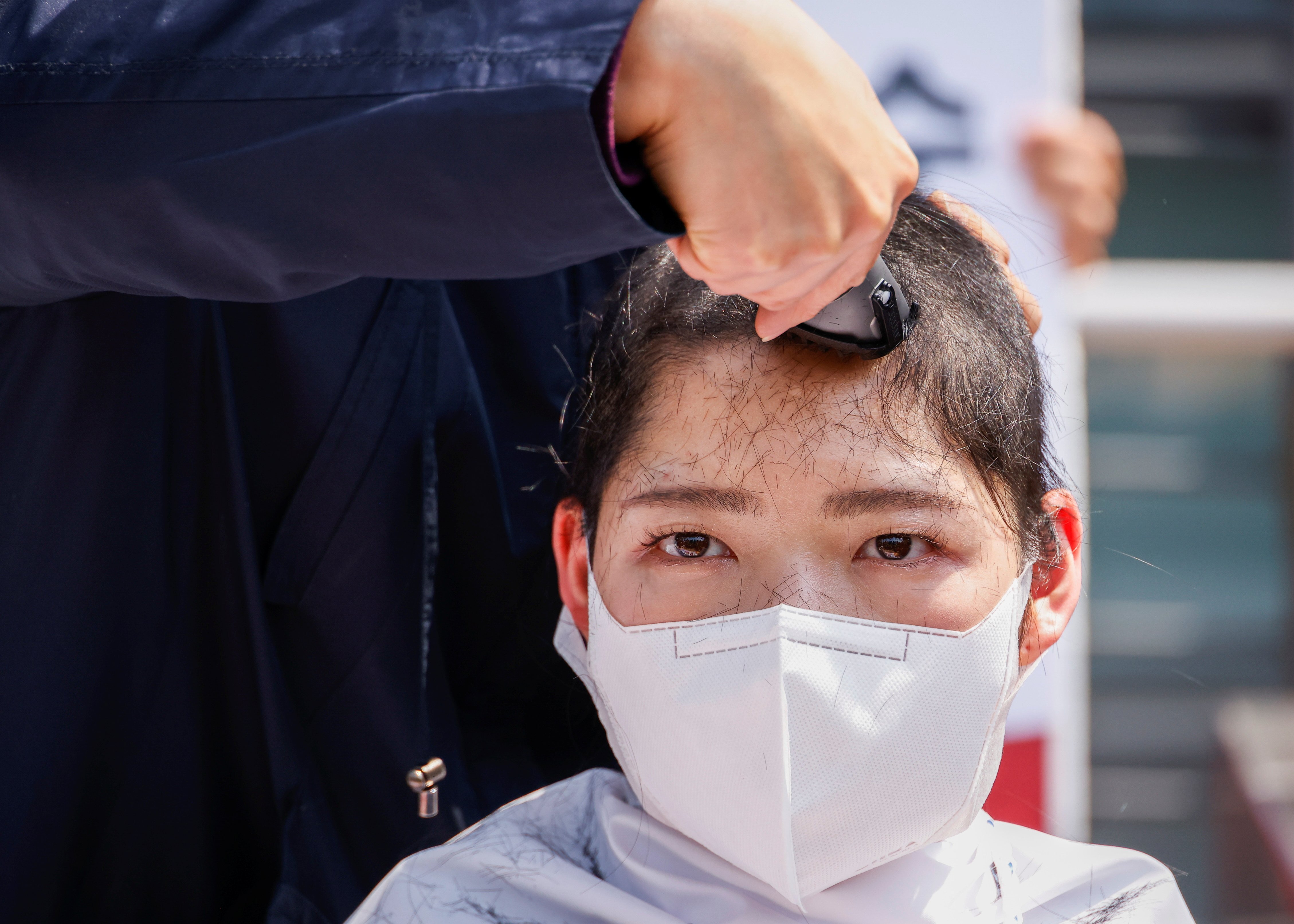 A South Korean university student gets her head shaved during a protest against Japan’s decision to release contaminated water from its crippled Fukushima nuclear plant into the sea, in front of the Japanese embassy, in Seoul, South Korea, on April 20. Photo: Reuters