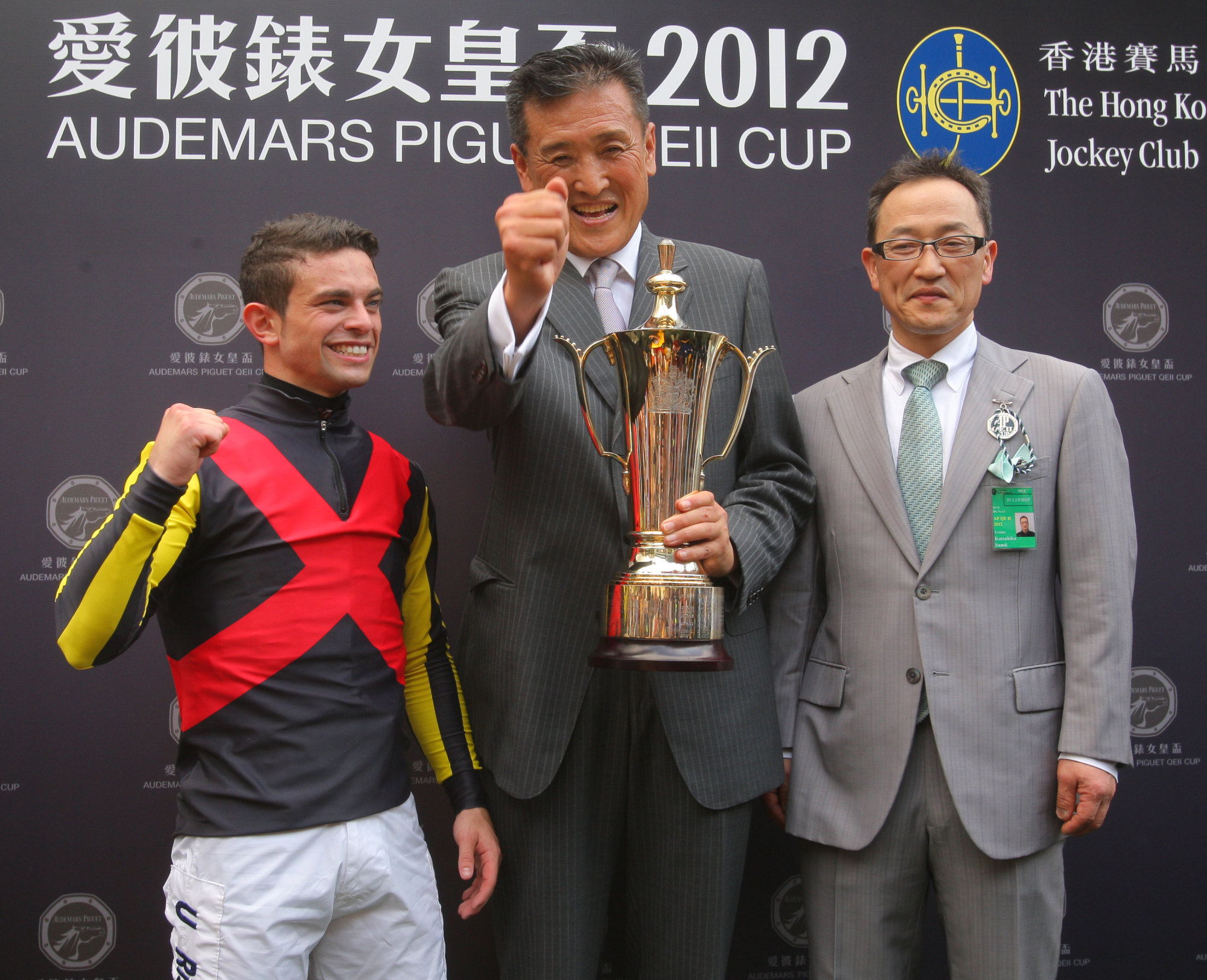 Katsuhiko Sumii (right) celebrates Rulership’s QE II Cup win in 2012 with jockey Umberto Rispoli and connections. 