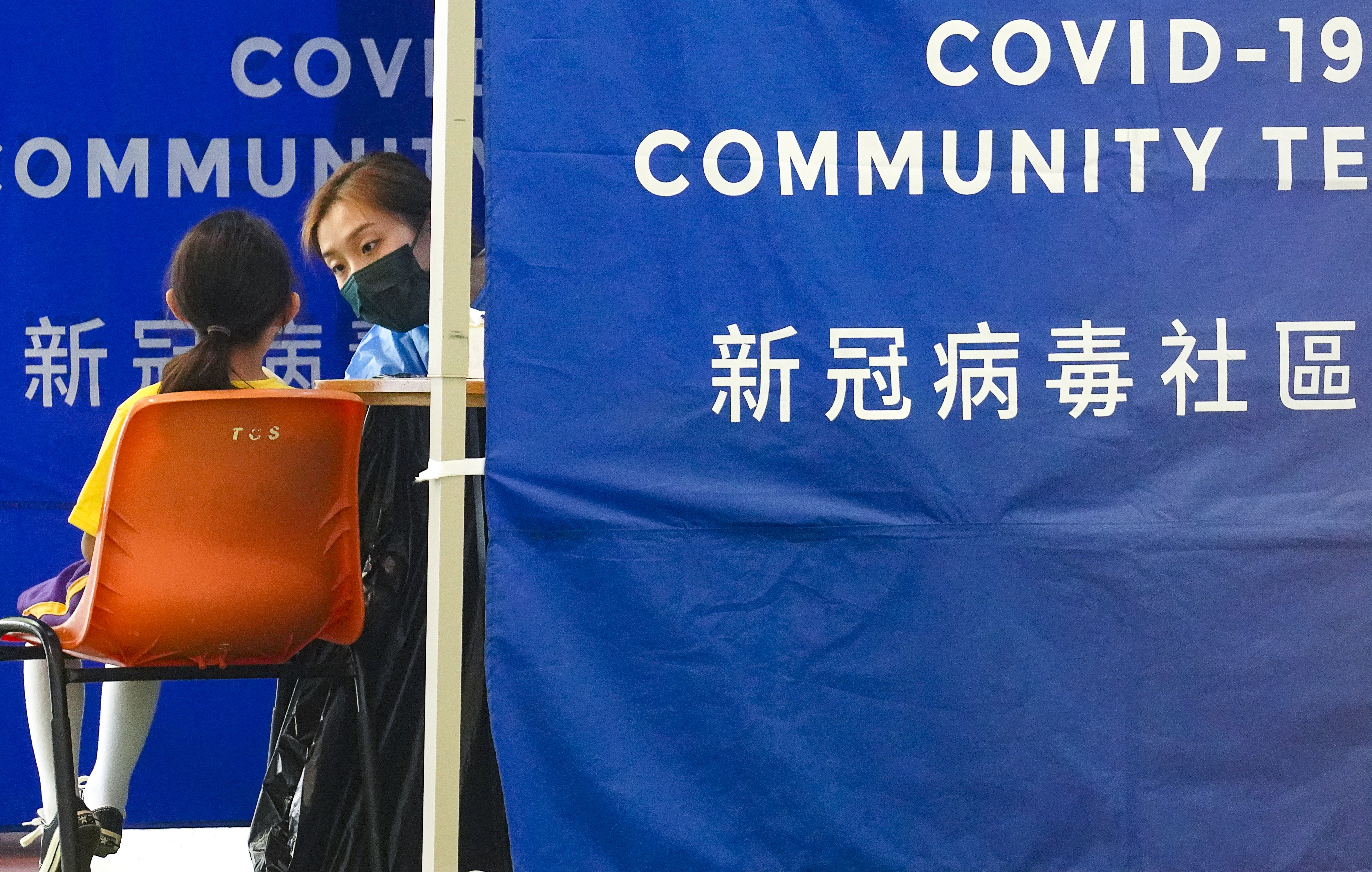 Pupils are screened for Covid-19 at a mobile testing point stationed at a school in Tai Wai. Photo: Winson Wong