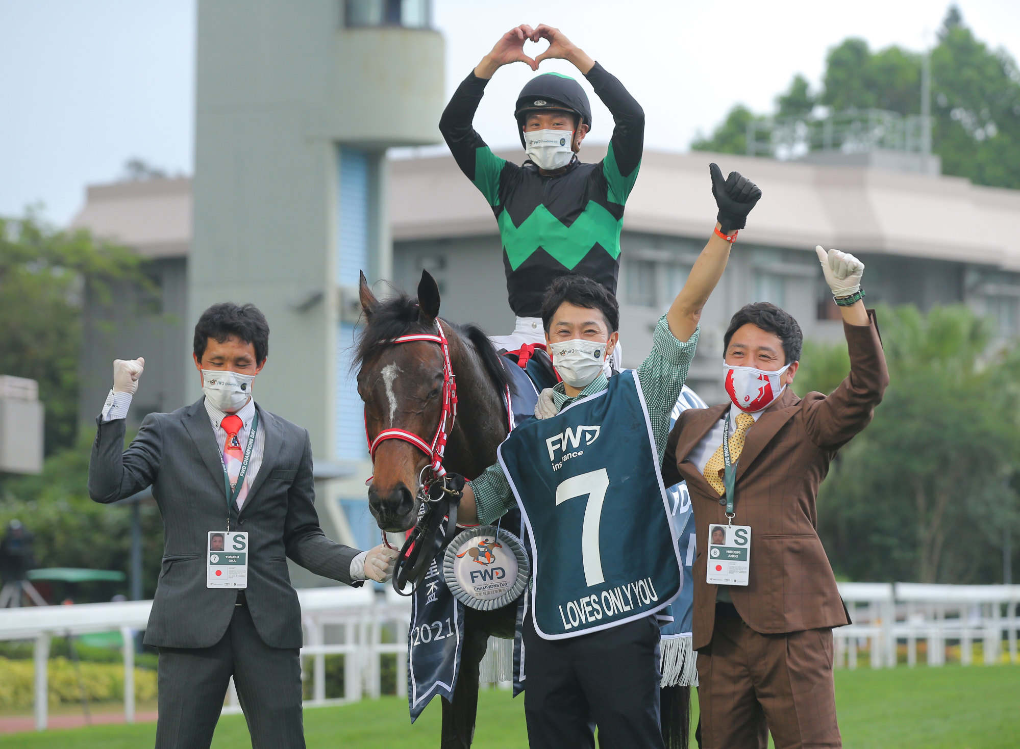 Jockey Vincent Ho celebrates Loves Only You’s victory with assistant trainer Yusaku Oka (left) and racing manager Hiroshi Ando (right).