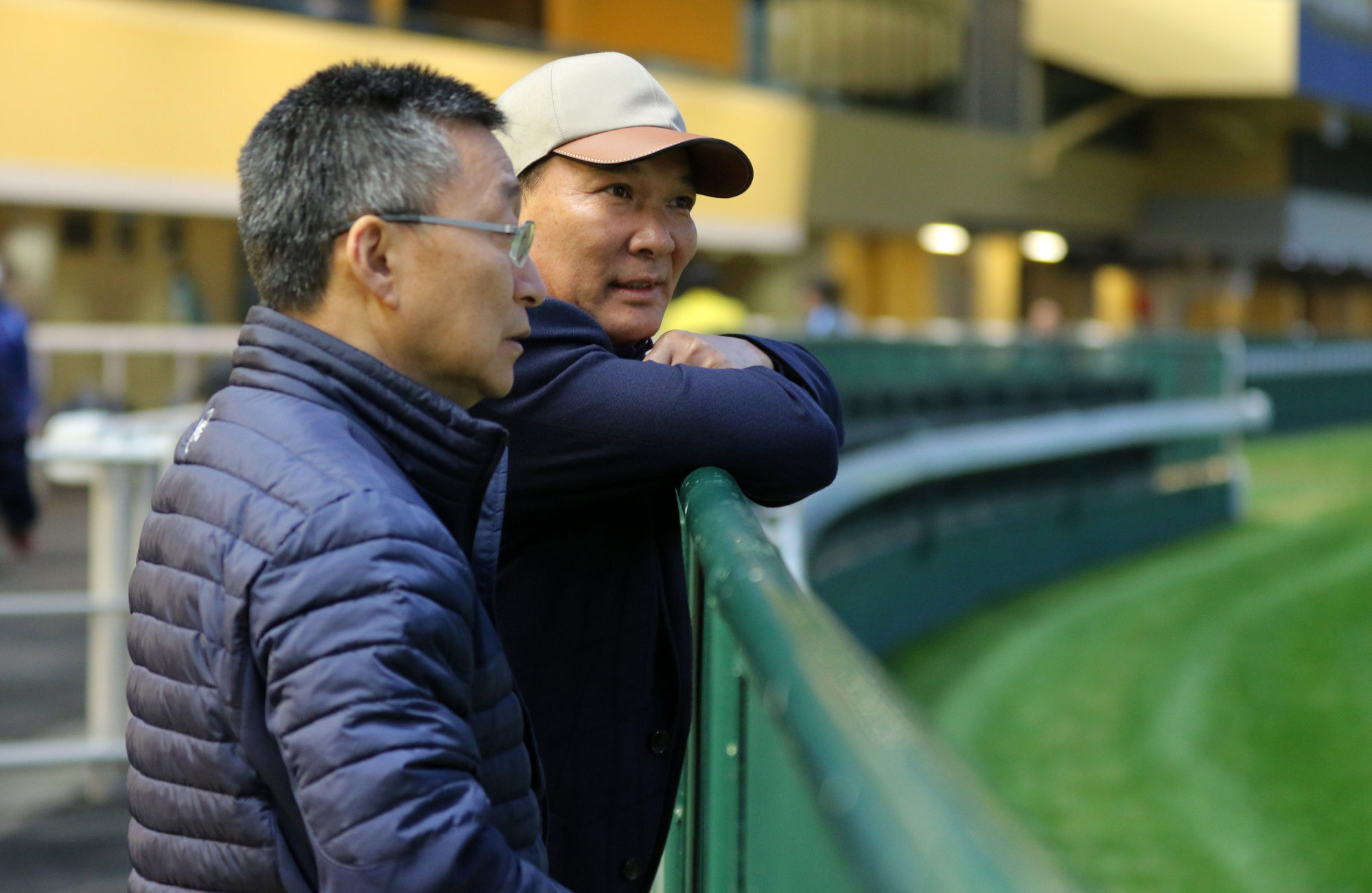 Trainer Francis Lui (left) watches More Than This trial with owner Huang Kai-wen (right) at Happy Valley.