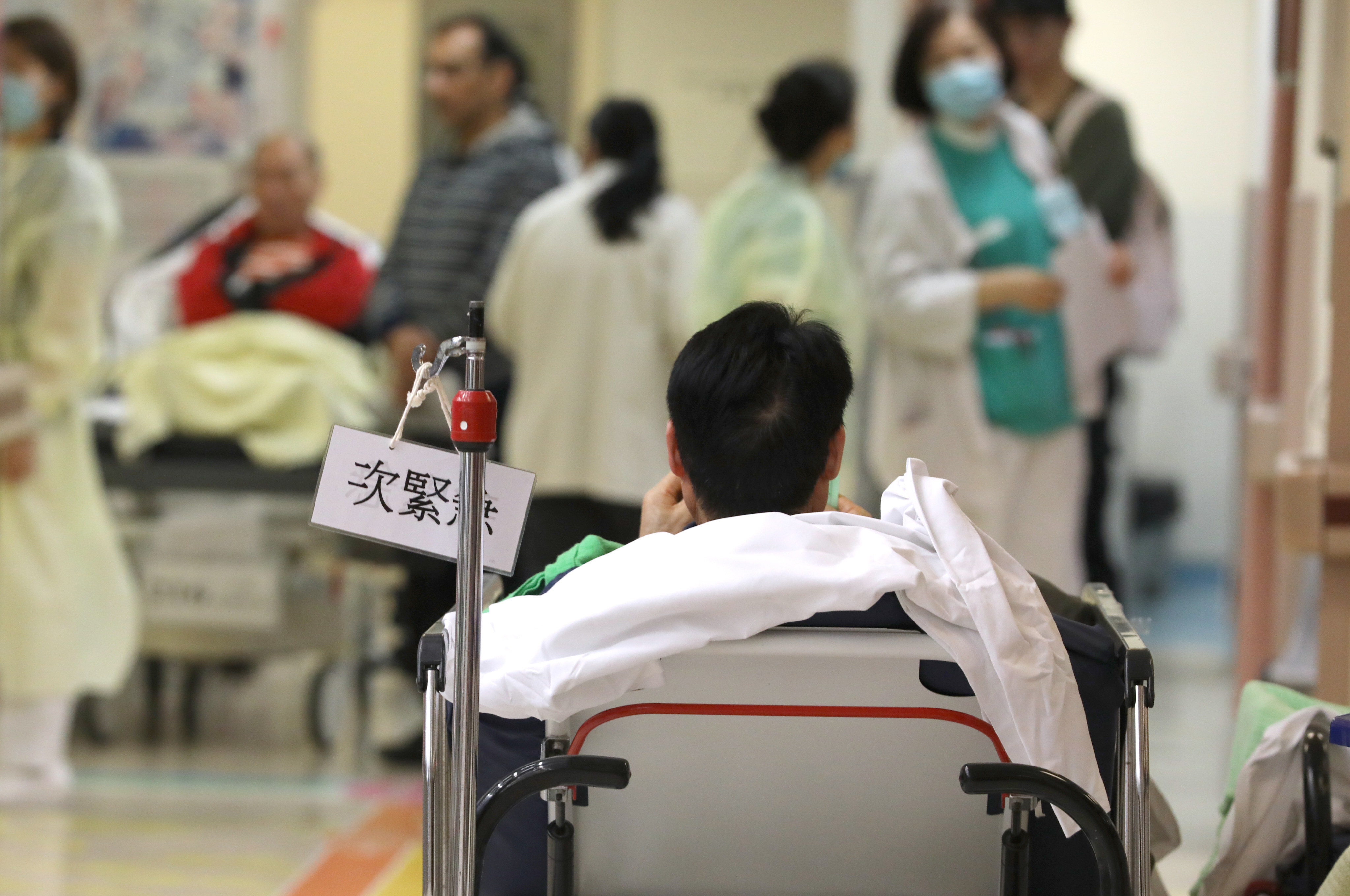 A patient waits in the accident and emergency department at Queen Elizabeth Hospital in Yau Ma Tei, on January 6, 2019. Hong Kong has two doctors for every 1,000 people, and a consequence of this is long waiting times and short consultations. Photo: Nora Tam


